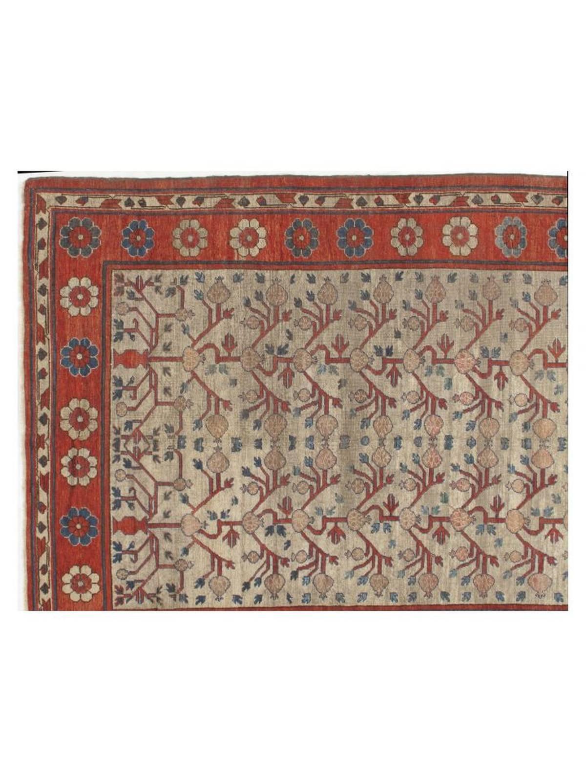 Antique, low pile Khotan with ivory field base with a floral design in red, gray, blue and dusty rose. Very good condition with minor wear consistent with age and use.