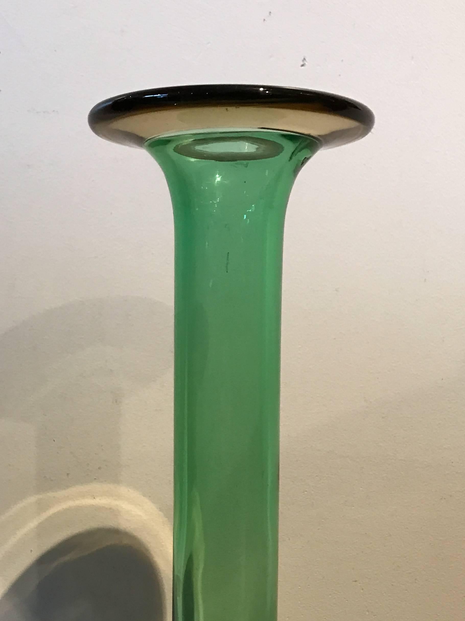 Green glass bottle vase attributed to Kastrup Holmegaard. Excellent condition, note the change from green glass to amber glass at the lip, a sign of quality glass blowing.