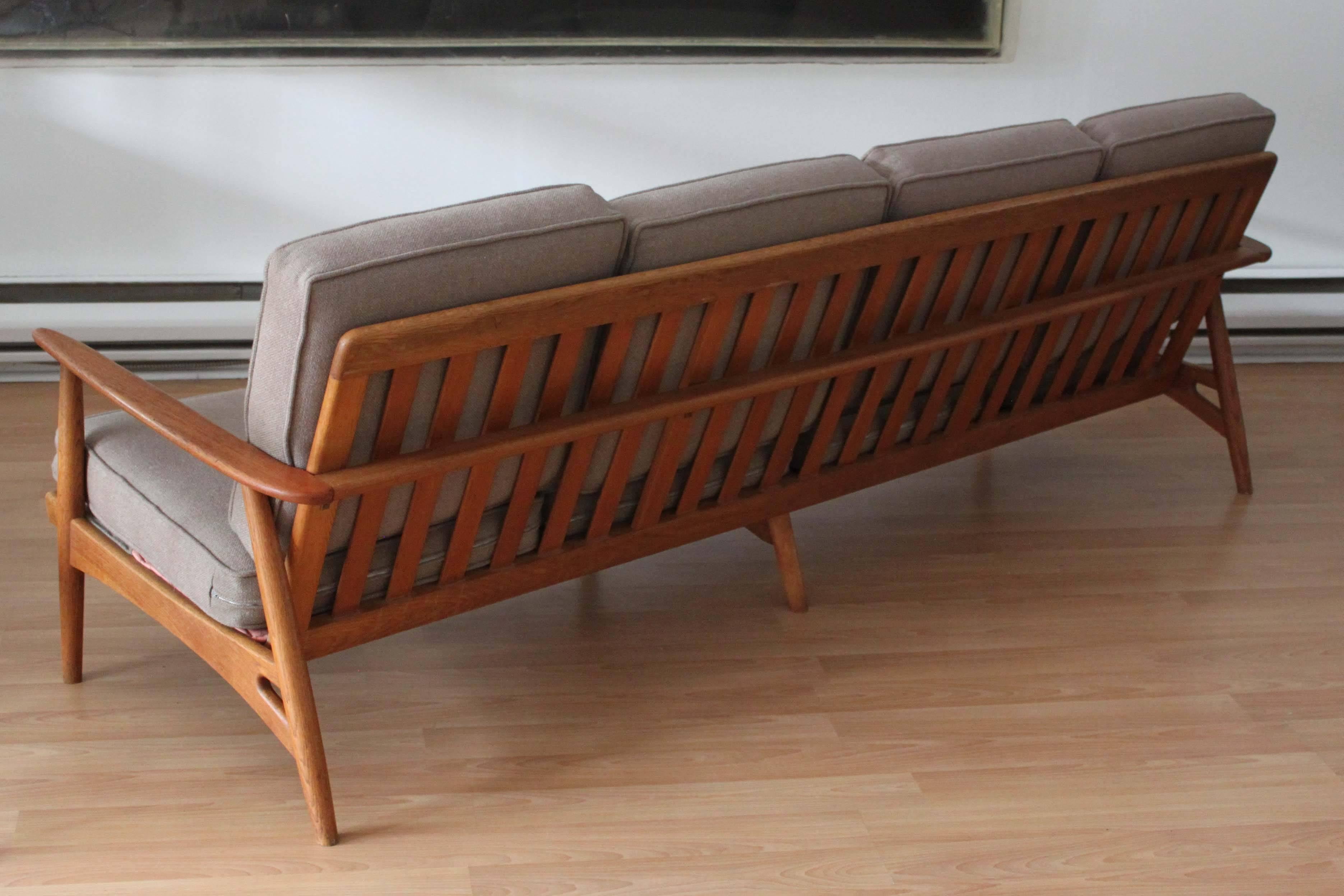 Danish modern teak four-seat sofa in the manner of Grete Jalk. New upholstery and cushions, frame in excellent vintage condition, very solid.