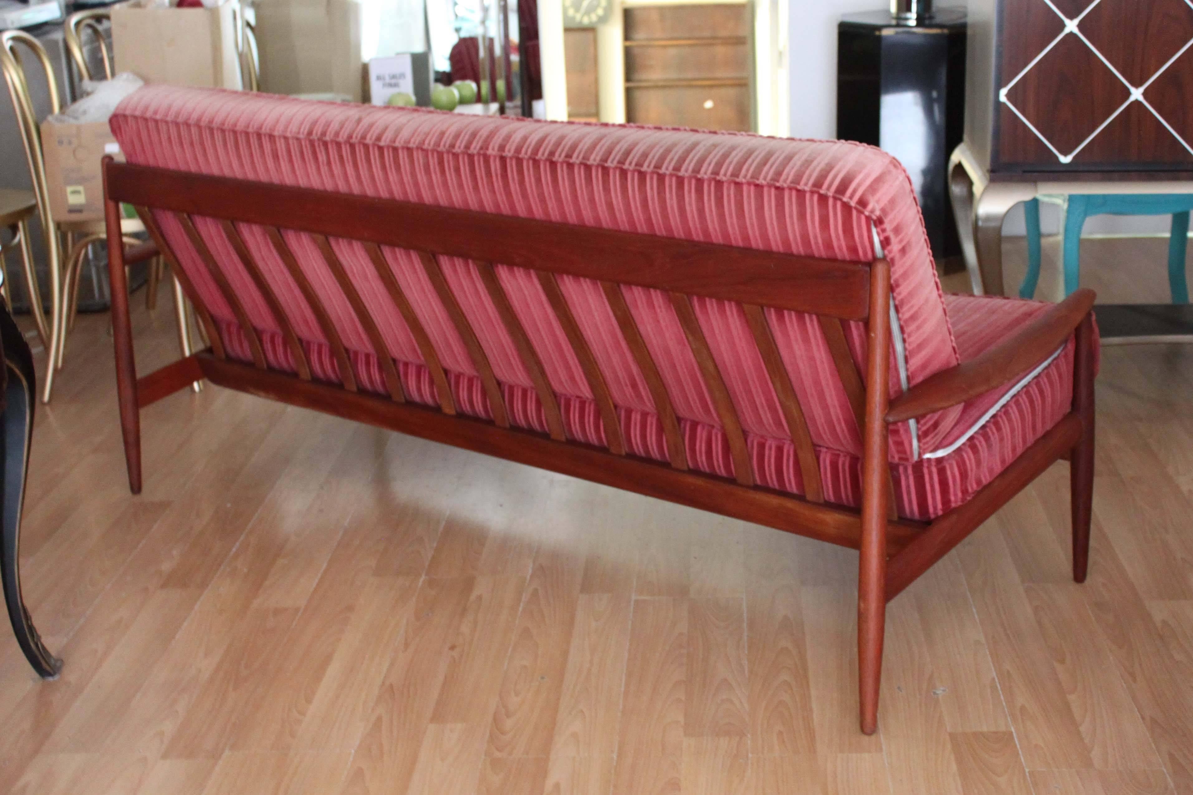 Teak sofa designed by Grete Jalk for France and Daverkosen, later France & Son, with two single floating cushions. Very good overall condition with minor professional re-gluing where the arms meet the backrest, see photos. Early France & Son marking