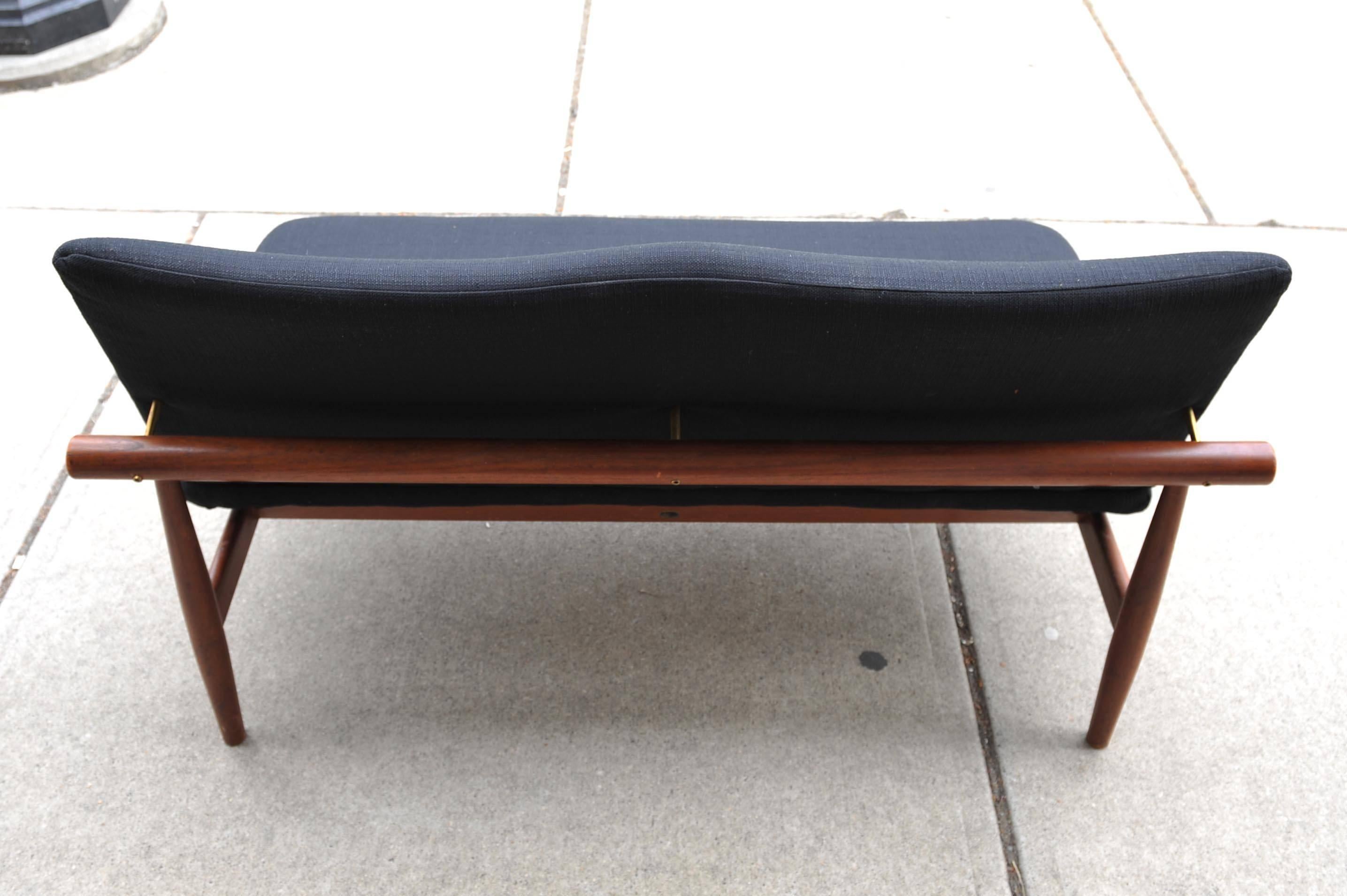 A rare Model 137 Japan sofa designed by Finn Juhl and manufactured by France & Son. The design of this sofa was inspired by Miyajima shrine off the coast of Hiroshima. New tweed upholstery over teak frame. Marked with original label.