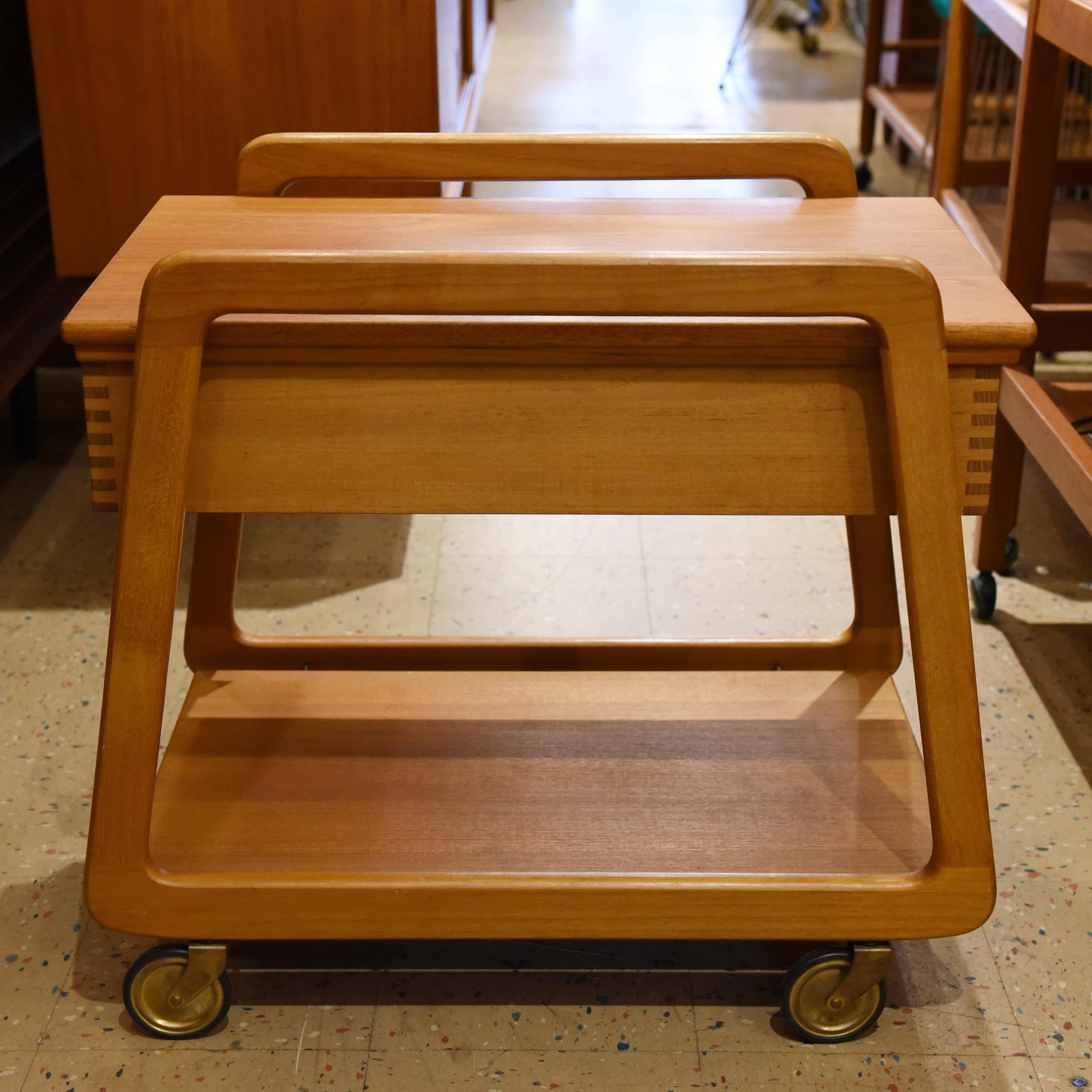 Danish teak mobile sewing cart/trolley with removable compartment. Cover plate can be pulled out on both sides. Very good vintage condition with original label.