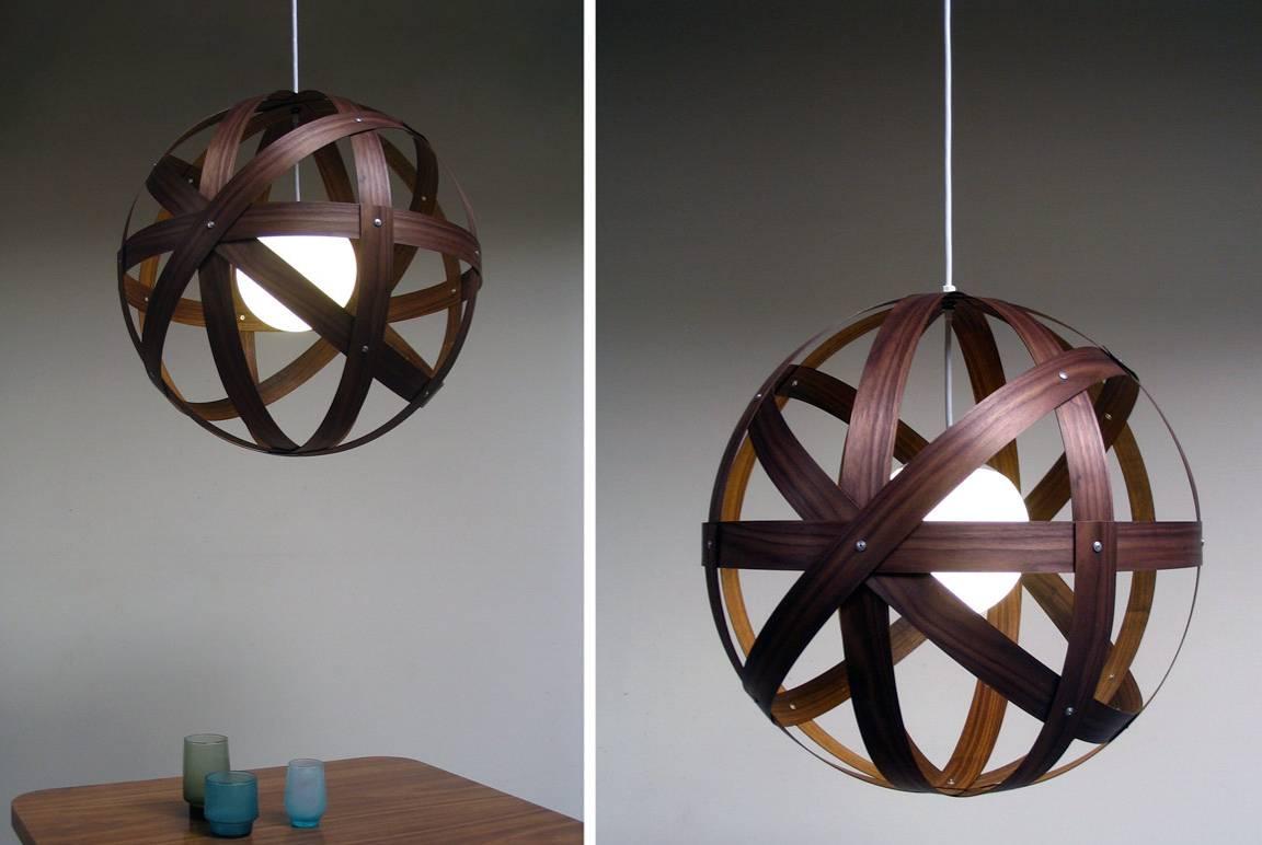 The Meridian 42" diameter pendant is a study in implied motion. Bands of locally sourced walnut finished in natural linseed oil and beeswax finish surround a glass orb mounted and hung from a cord and aluminium canopy. Lamping is a medium base