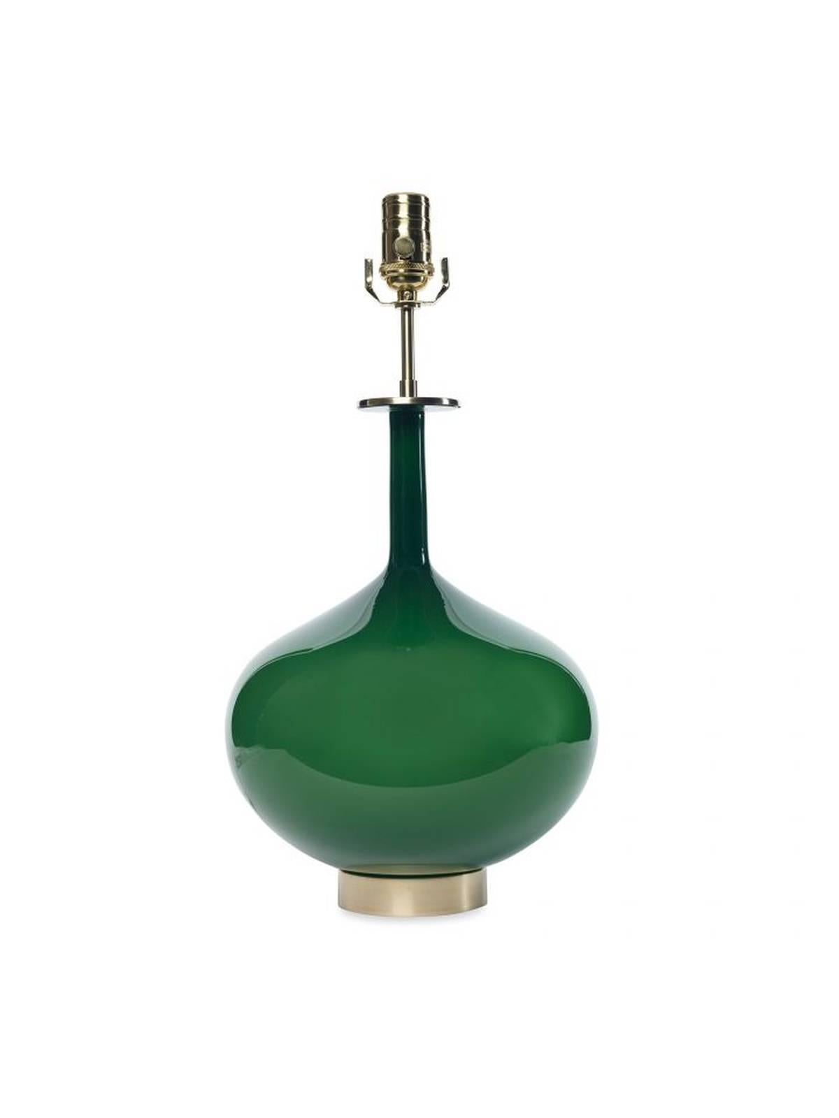 The Eden table lamp by Joe Cariati in handblown emerald green glass, finished with a brass base, matched teardrop finial and an off-white shade.