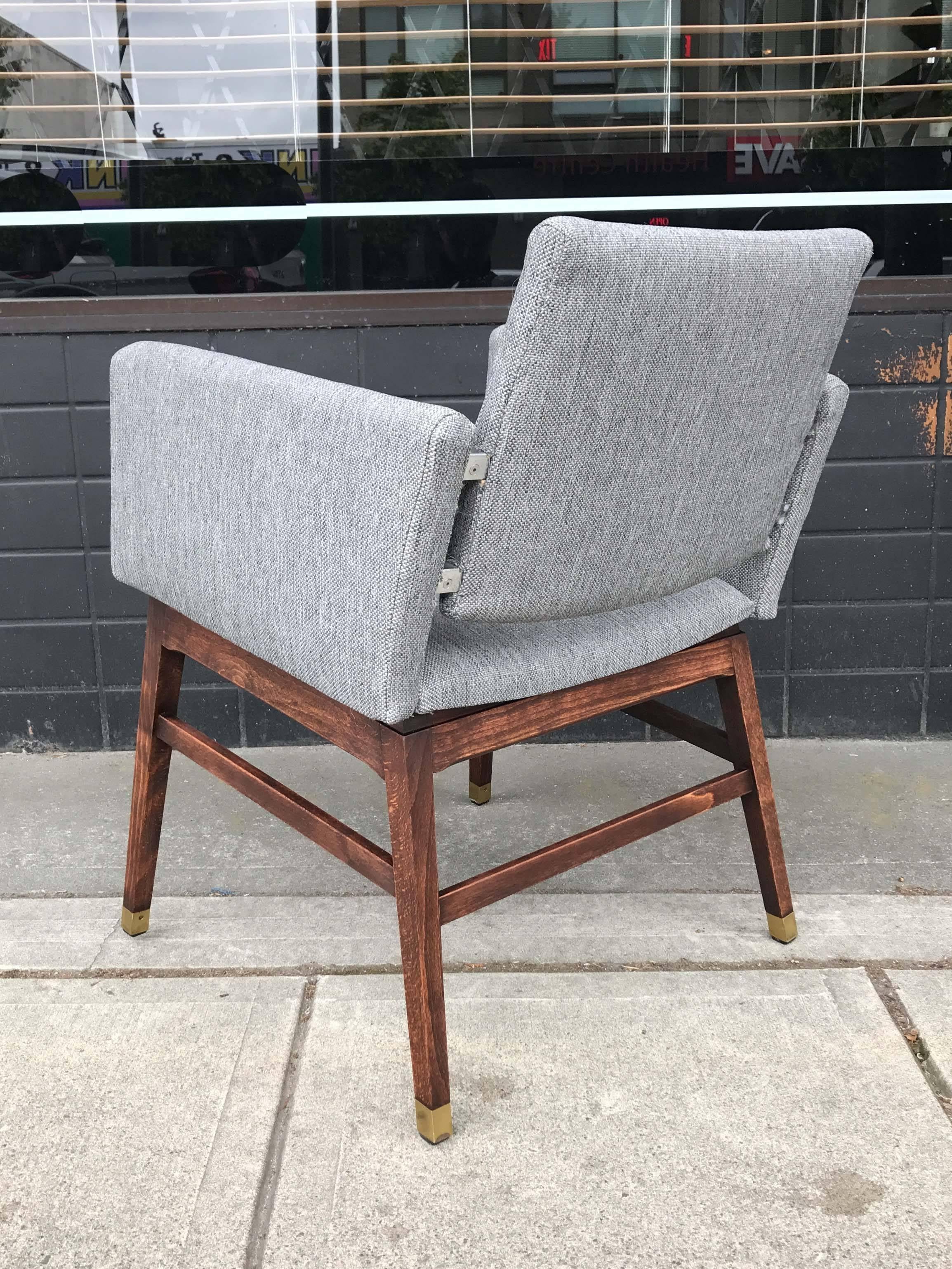 Kay Kørbing armchair with wood base and brass sabots. Reupholstered, solid vintage condition. Original label on base.