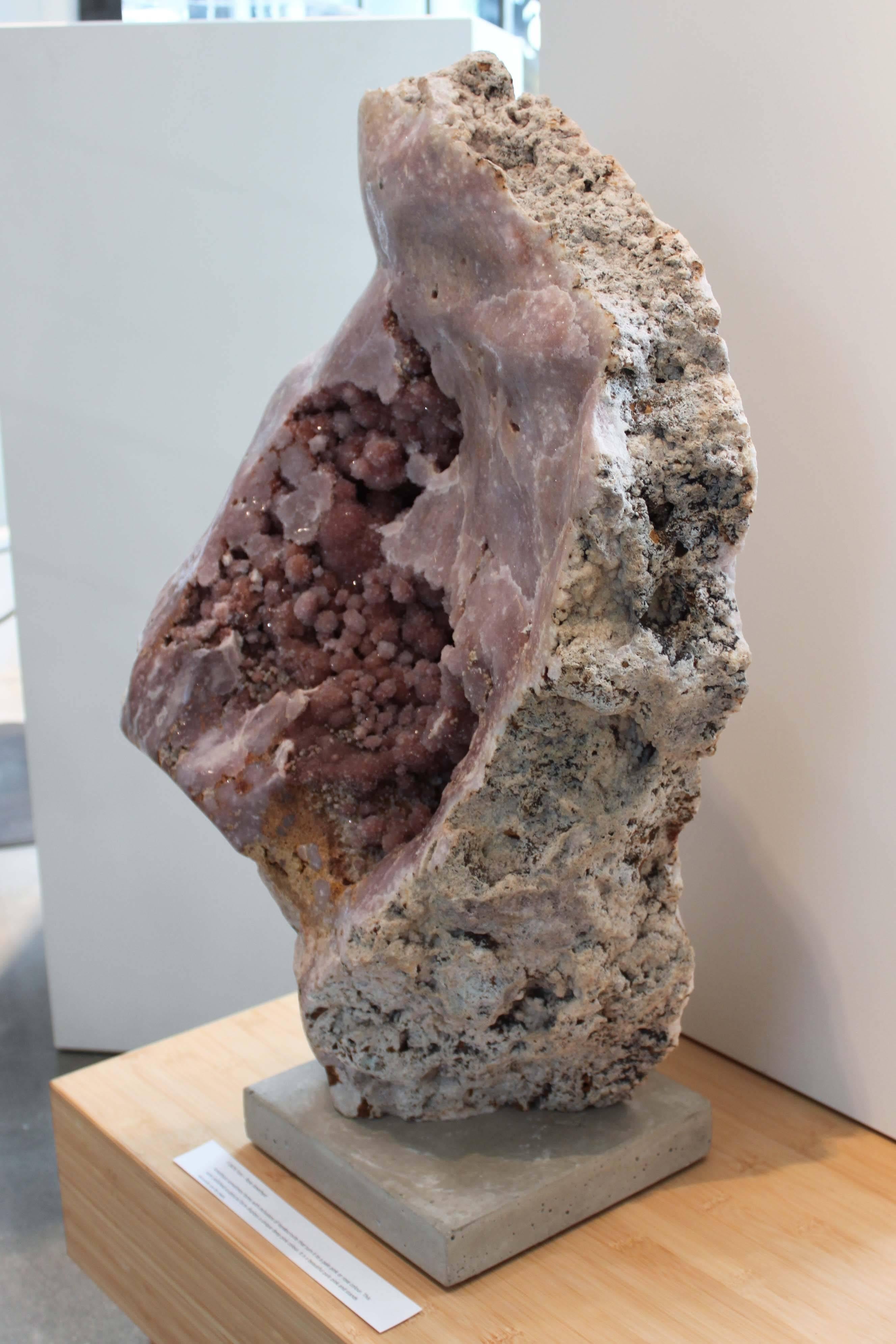 Amethyst sometimes forms with inclusions of lepidocrocite that turn it to a pale pink or rose color. This semi-polished sculptural form displays a unique deep-pink colour and stands securely on it’s own.
