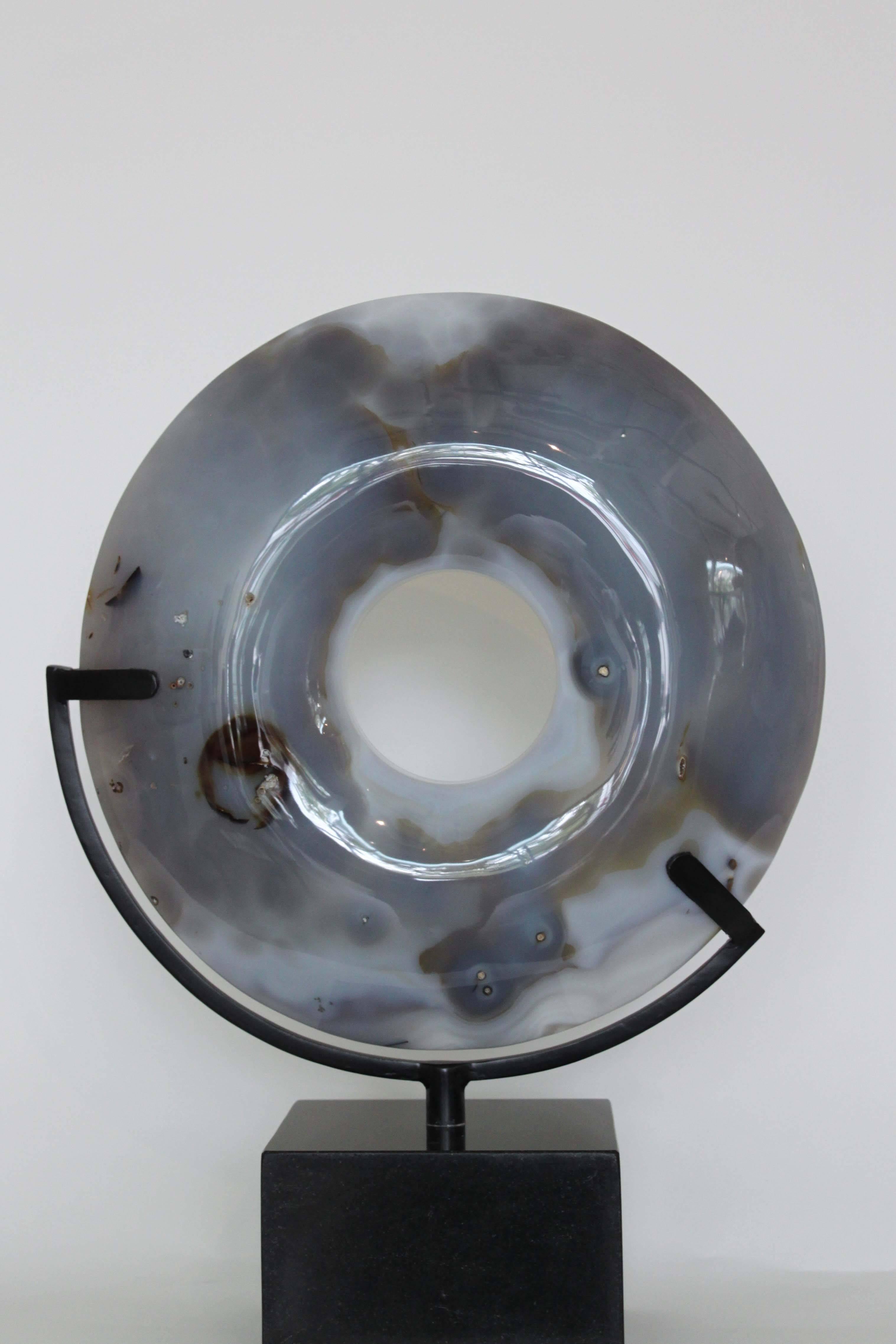 A beautiful handcrafted disc made of agate from Madagascar. Set atop a custom granite base.