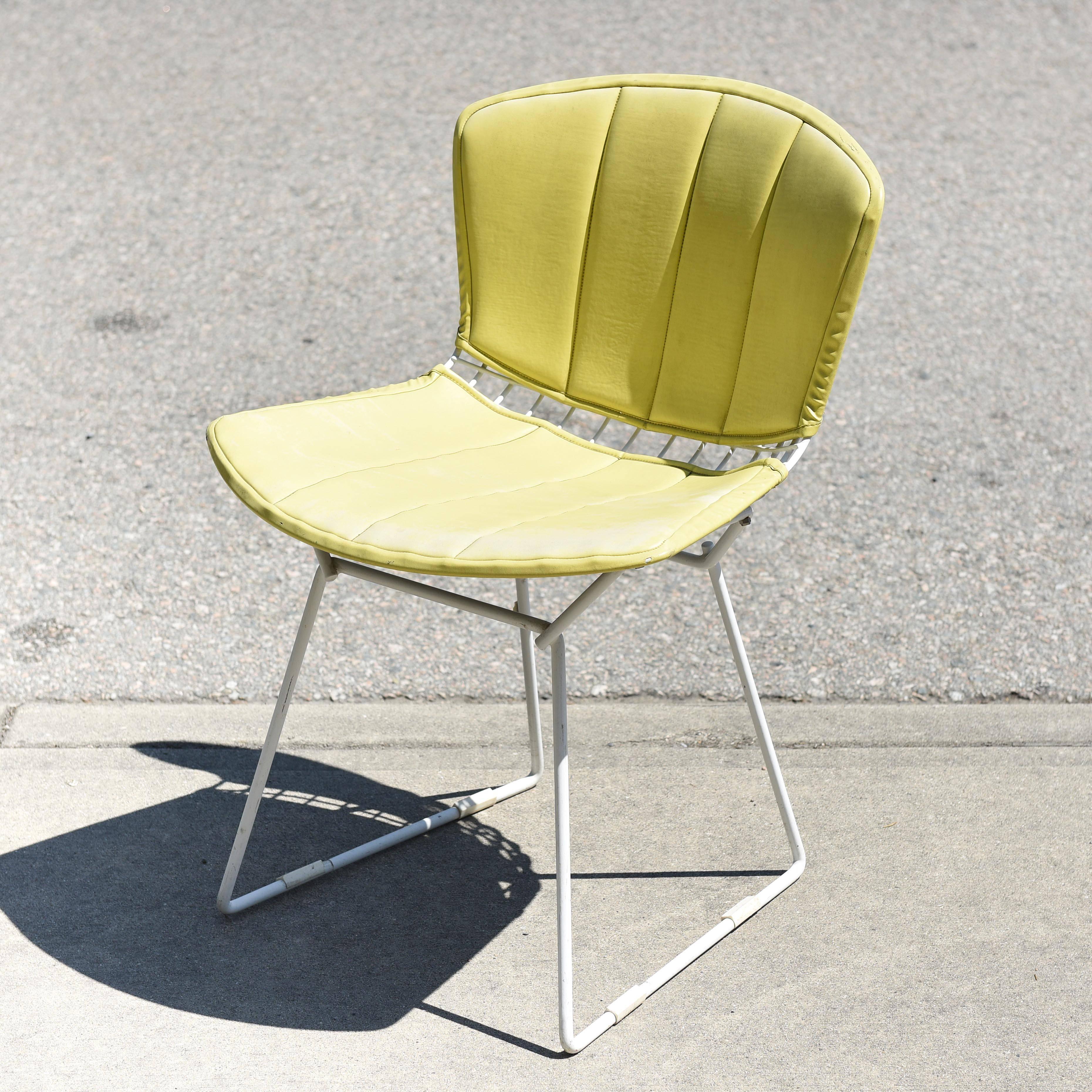 Bertoia wire chair in original condition. Vintage yellow vinyl upholstery has minor tear. Original tag on bottom.