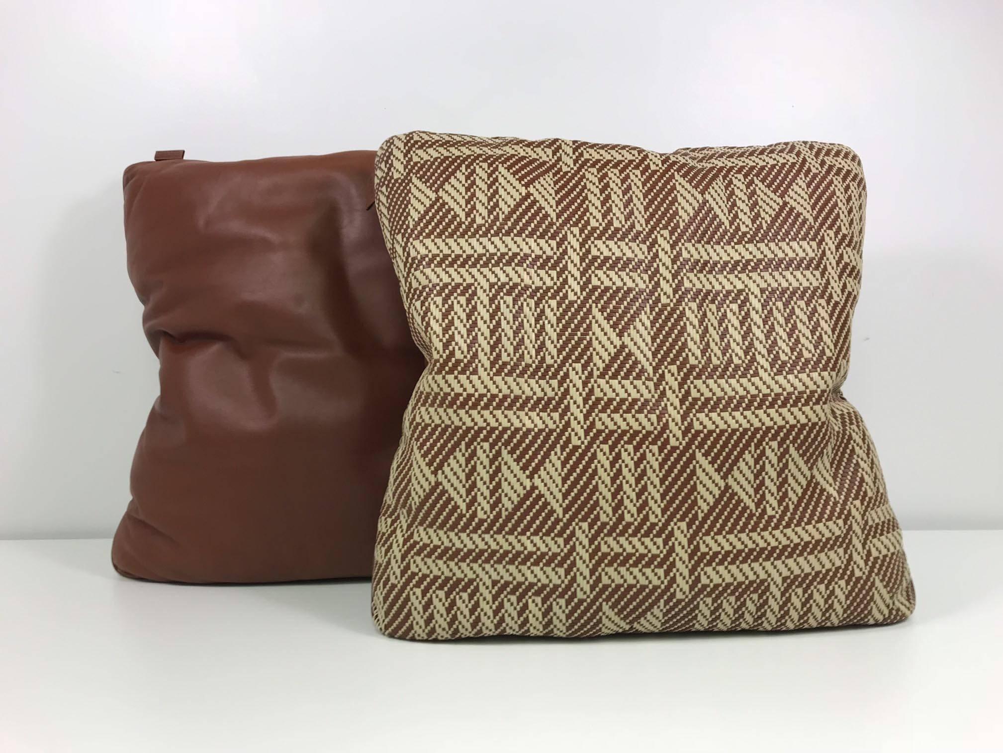 A pair of woven leather pillows by Hermès with geometric pattern. Labelled on seam.