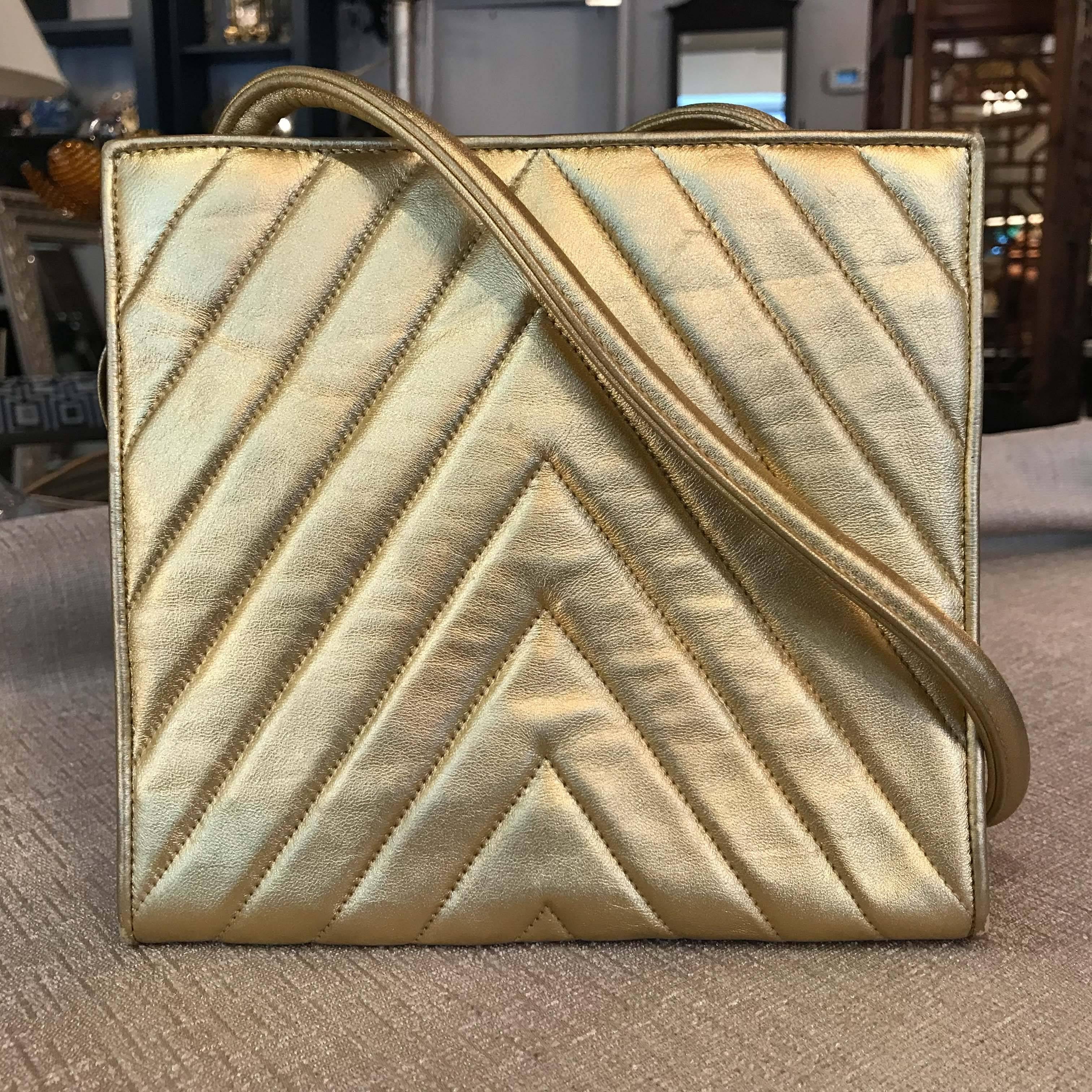 A rare gold vintage lambskin Chanel bag with rolled leather strap.