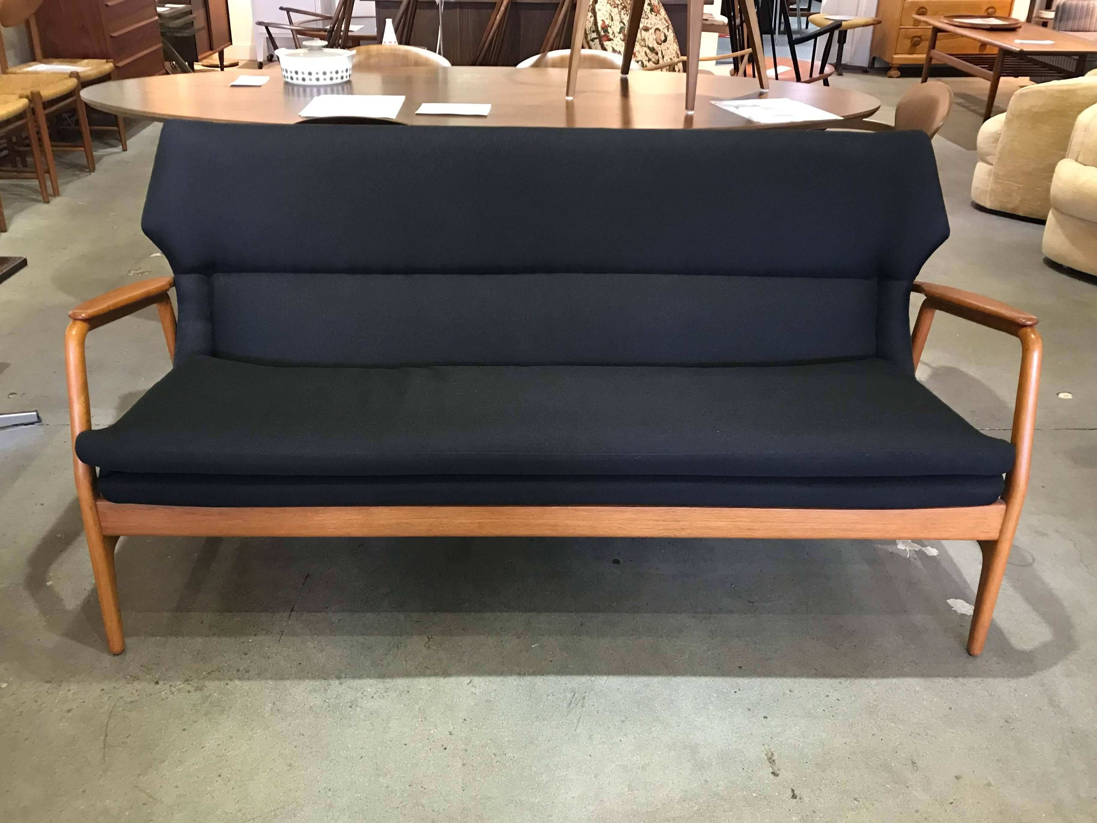 Sofa with solid teak arms and back rail, designed by Aksel Bender Madsen for Bovenkamp. Fully reconditioned with new black upholstery. Note the small crack in the back rail on the corner; this does not affect the stability of the settee which is
