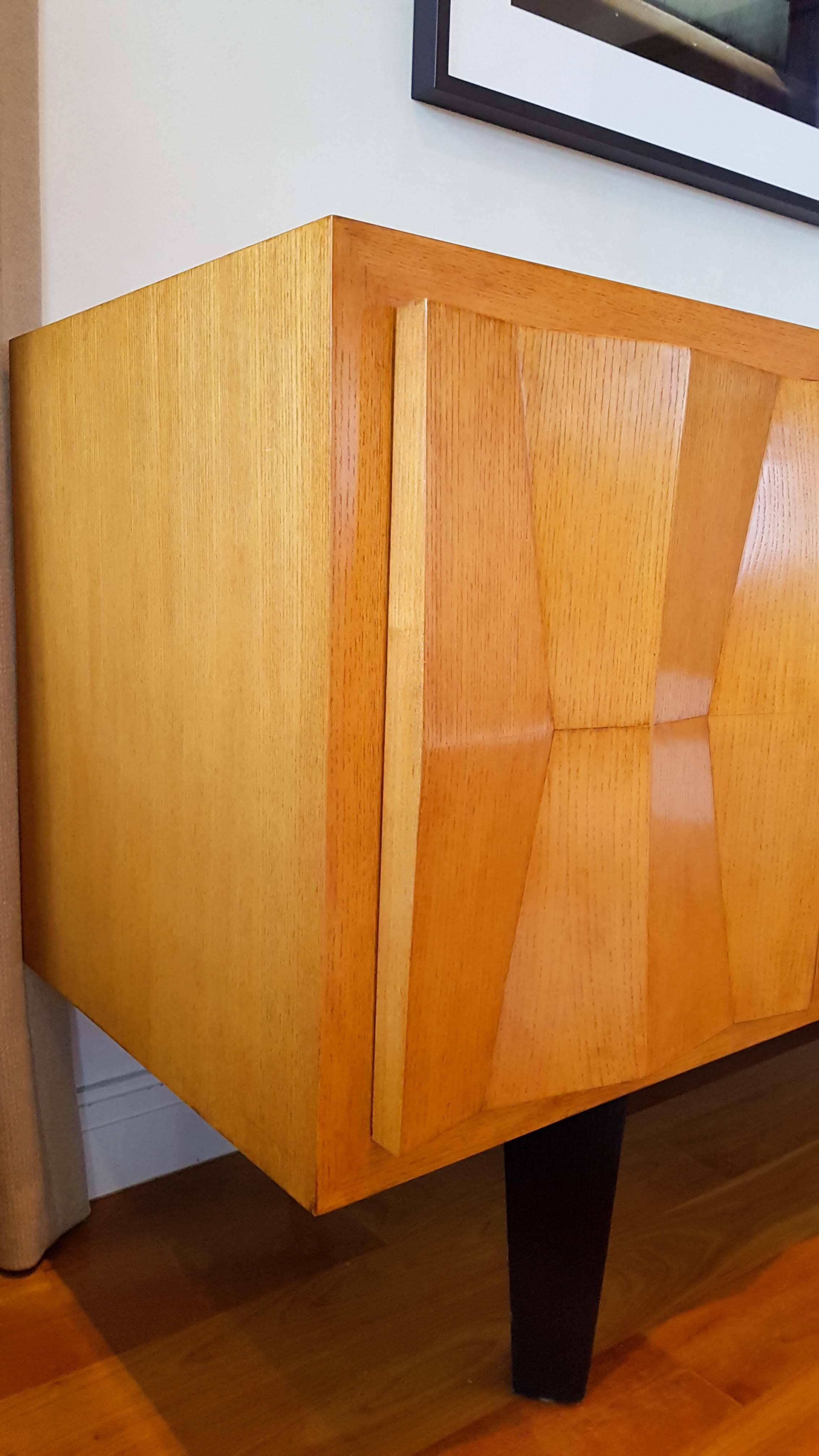 The Edo Credenza by Therien Studio Workshops. The case is made of ashwood and ashwood veneer and sits atop ebonized legs. Custom made for a private client in 2004, in excellent overall condition with minor wear consistent with occasional use.