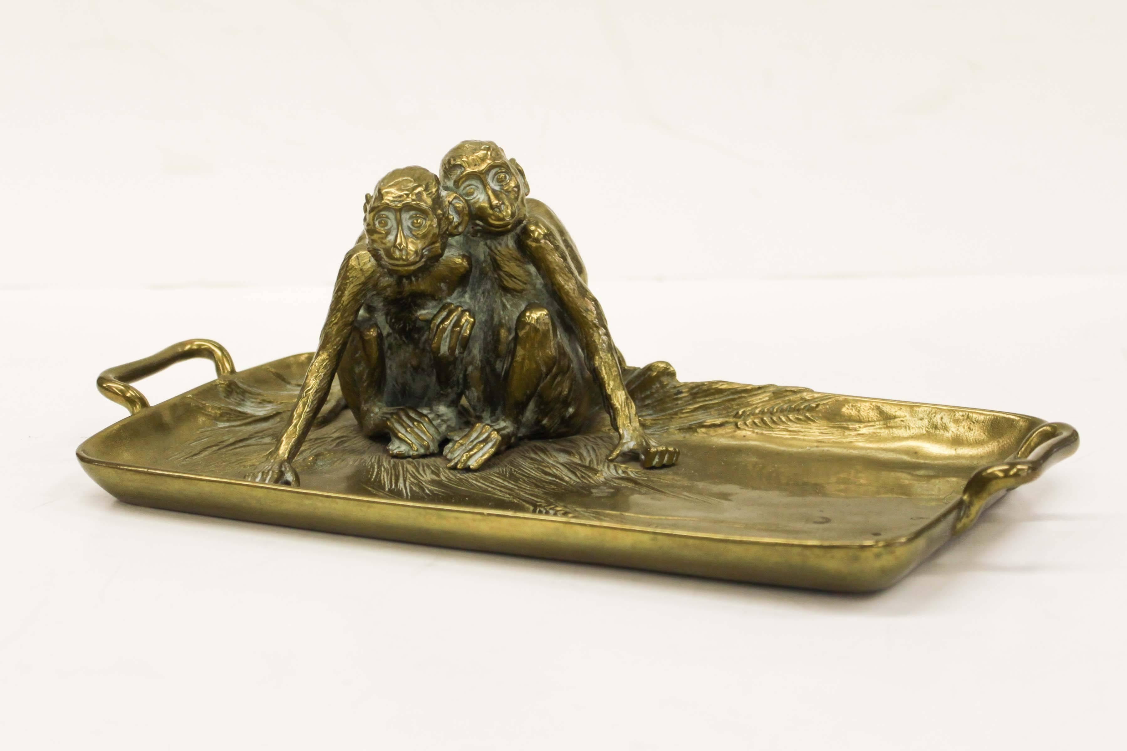 Beautifully cast brass tray by Franz Bergmann, signed "Nam Greb" (Bergman backwards). A pair of monkeys huddle in one corner of the tray over reliefs of wheat sheaves. The piece is especially unusual as most of Bergmann's work was produced