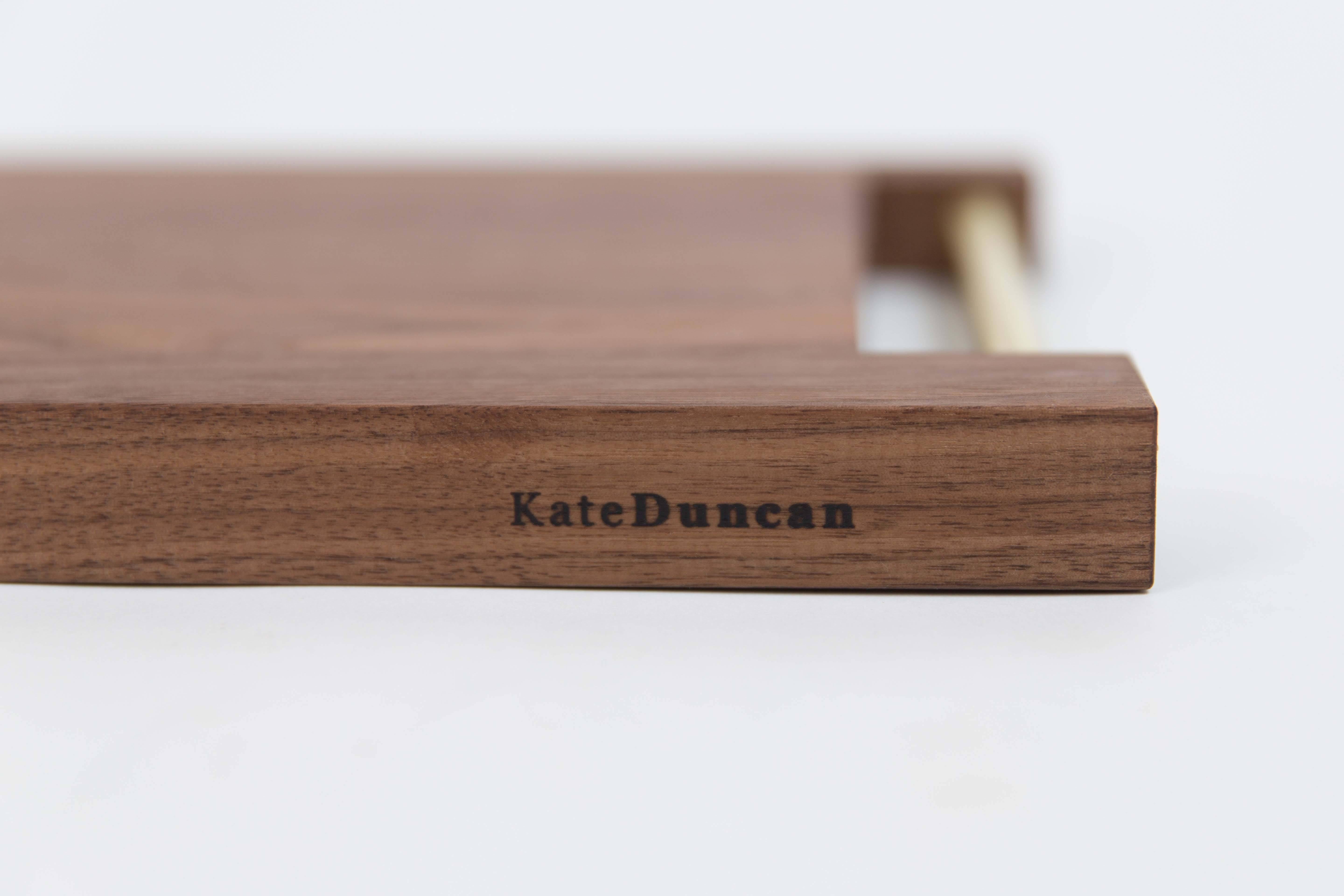 Comprised of a metal handle of either stainless steel or brass, inset into solid black walnut or maple to create a server that is beautiful yet functional. The Kate Duncan range of 