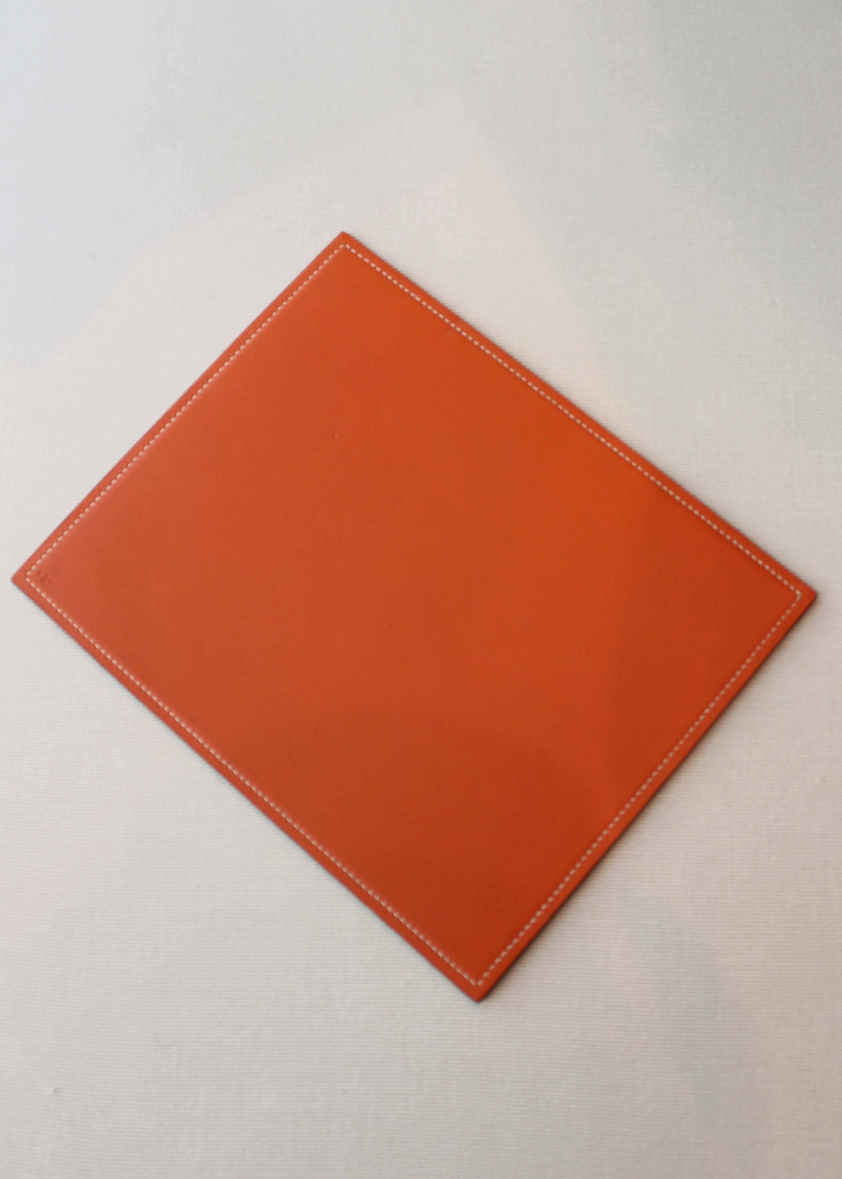 Vintage Hermès reversible leather mouse pad, brown and orange with white stitching. Minor wear/color variation at bottom center of brown side near stamp, see photos.