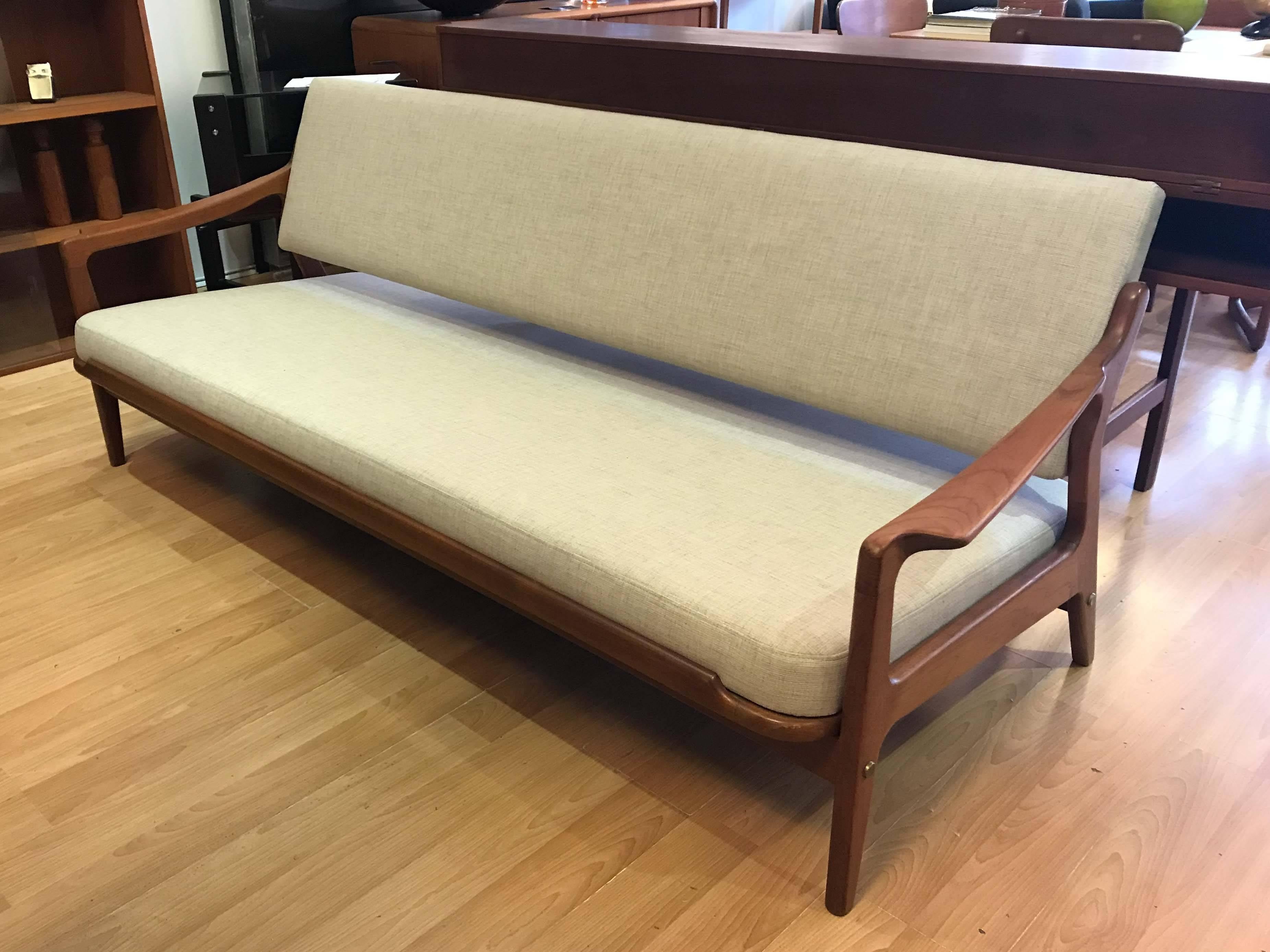 Daybed and sofa by Arne Wahl Iversen produced in, and marked "Denmark". This versatile piece converts from a standard sofa to a sturdy bed. In very good original condition with original upholstery. A second daybed in different upholstery