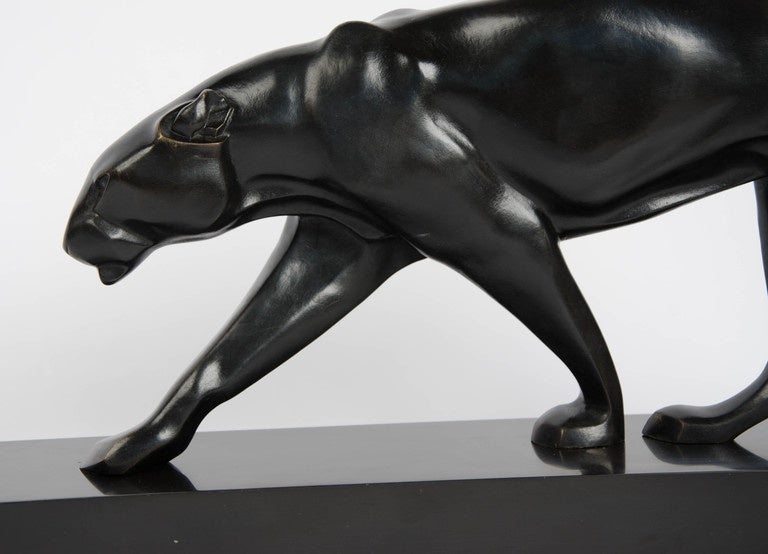 Panthère en Marche, an Art Deco bronze sculpture by Maurice Prost (1894-1967). A patinated bronze model of a stylised panther walking along an angled slate base.

Signed M. Prost and engraved Susses Fres Editrs Paris to base

H 31cm, L 64cm, W