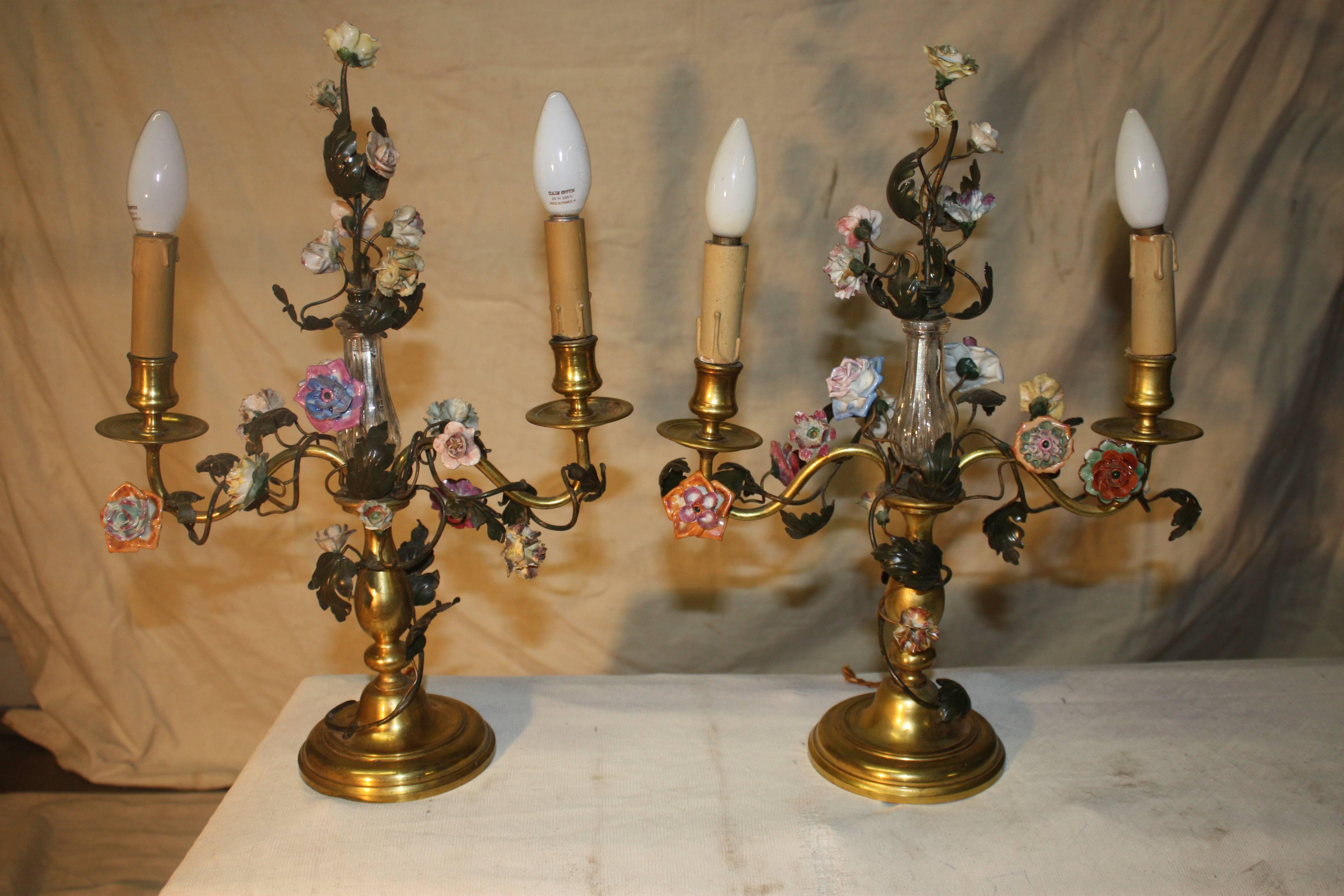 Pair of 19th century French bronze candelabras with porcelain flowers, Louis XVI style.