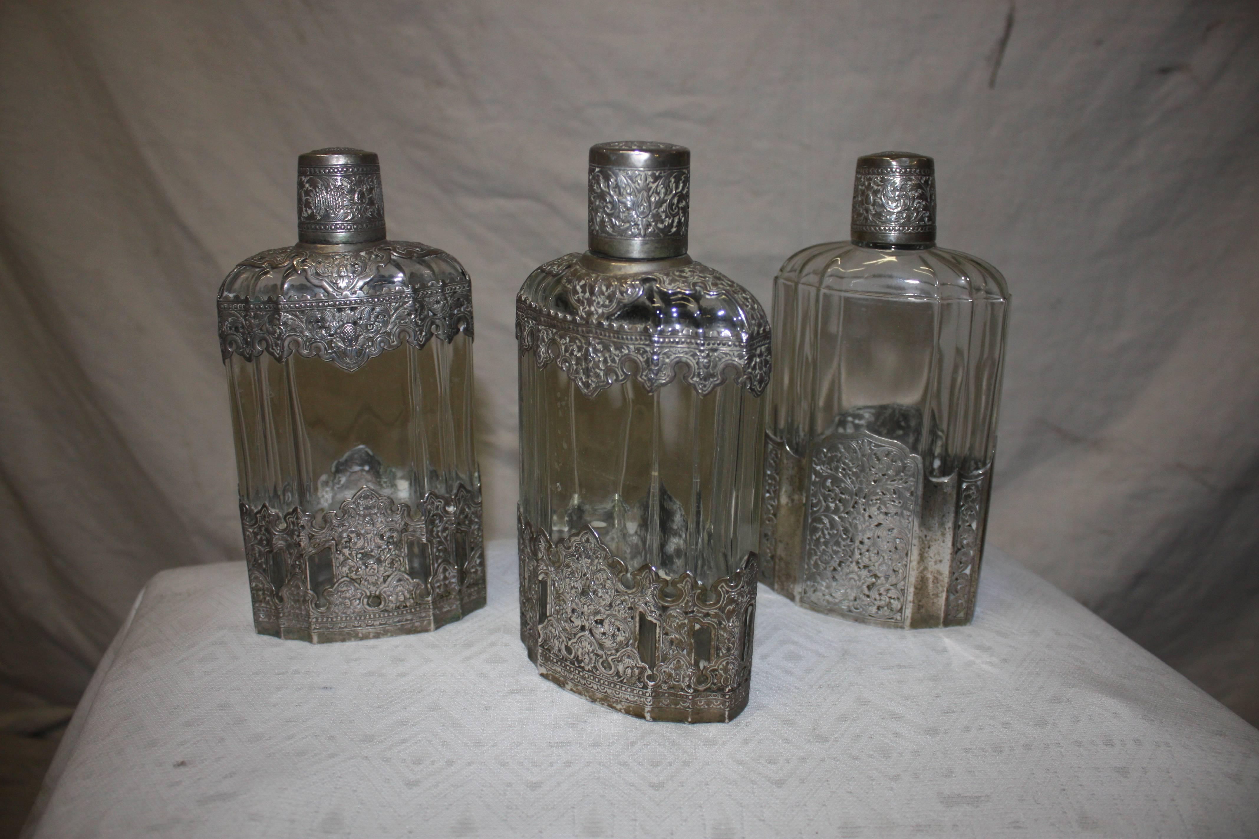 Set of 19th century glass bottles recovered of silver. Signed 