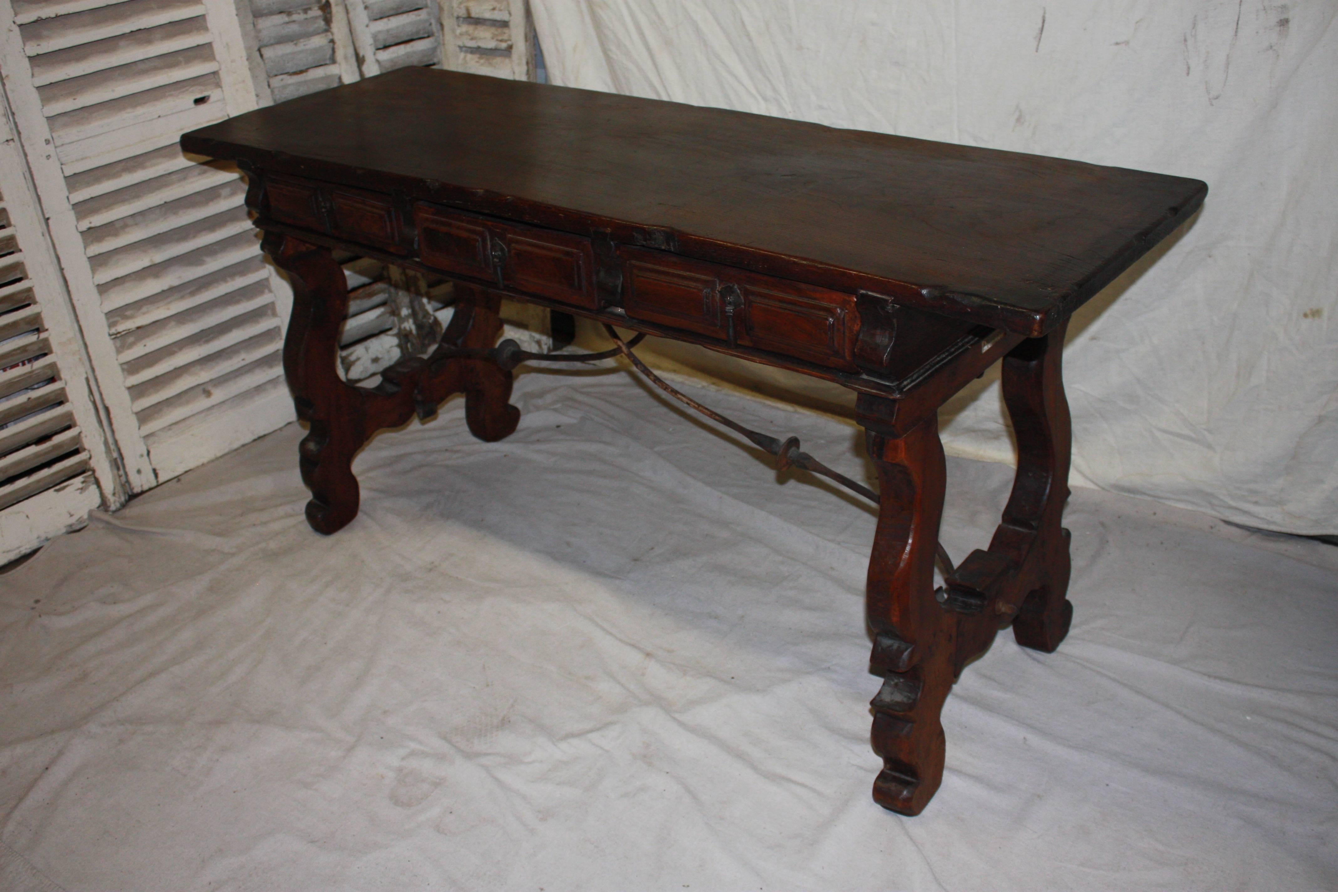 19th century French console table in walnut from the south of France. Carved legs and iron stretcher, 3 drawers in the front, beautiful warm patine.
