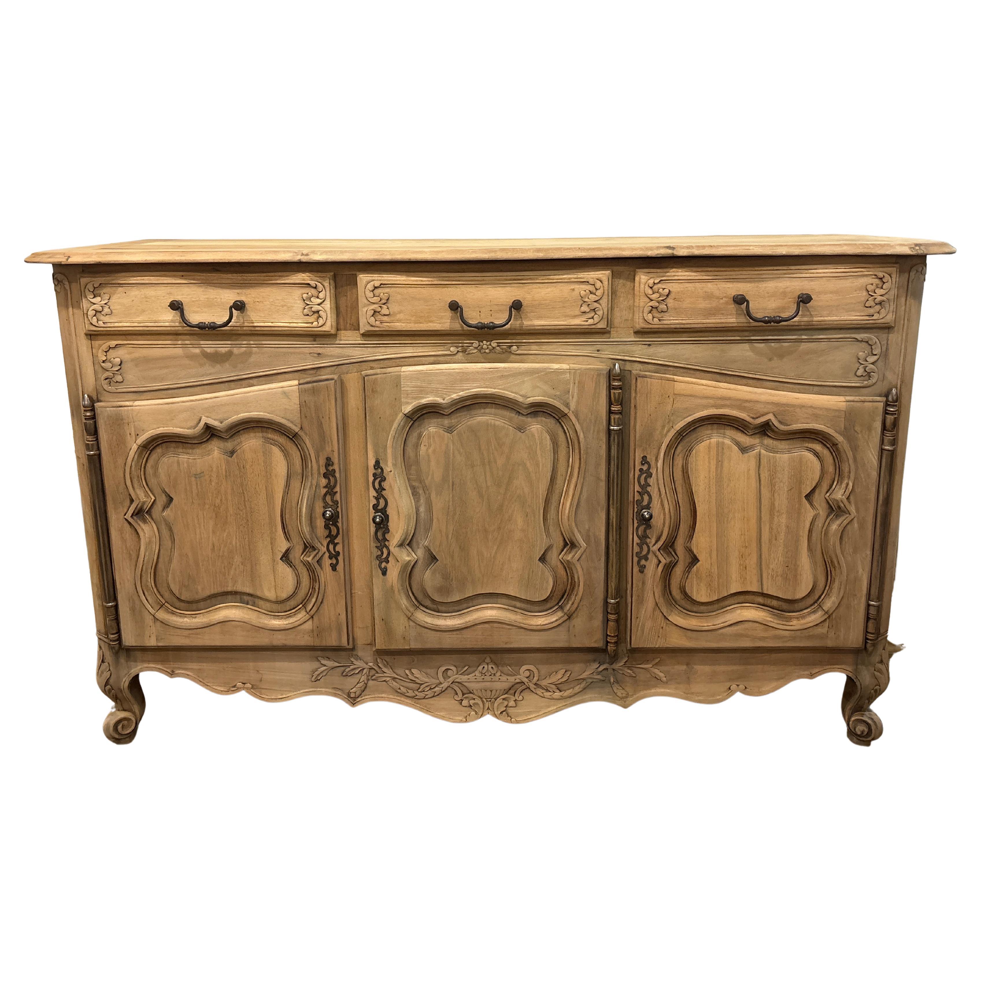 This wonderful sideboard is made of flamed walnut. The wood is raw and has been refinished. The front edge of the top has a curved movement.