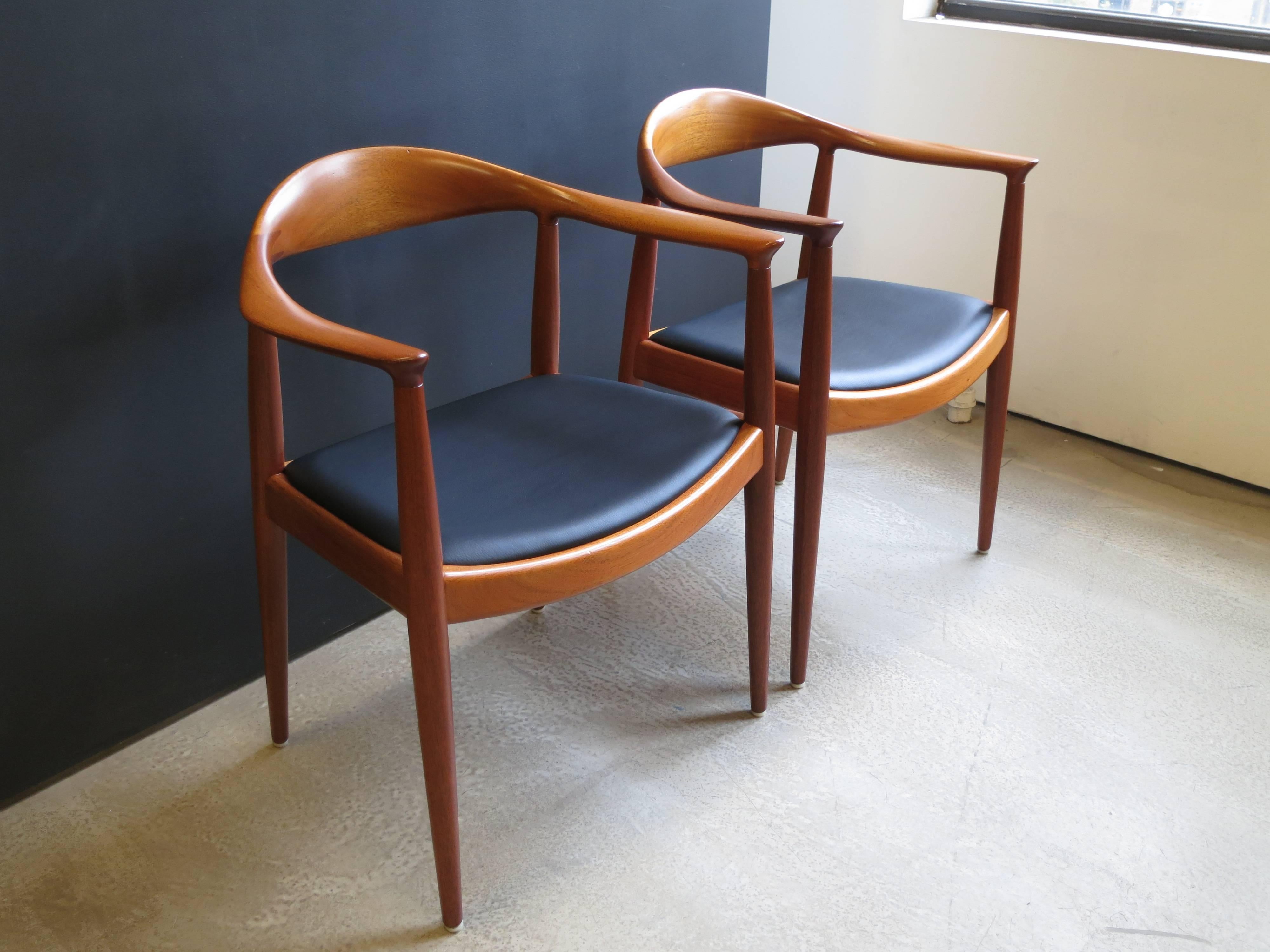 Cabinetmaker’s brand of Johannes Hansen on the underside of the frames.
Frames of mahogany, seats in black leather.

Arm height is 27.50 inches.

Literature
Grete Jalk, ed., 40 Years of Danish Furniture Design: The Copenhagen Cabinet-makers’