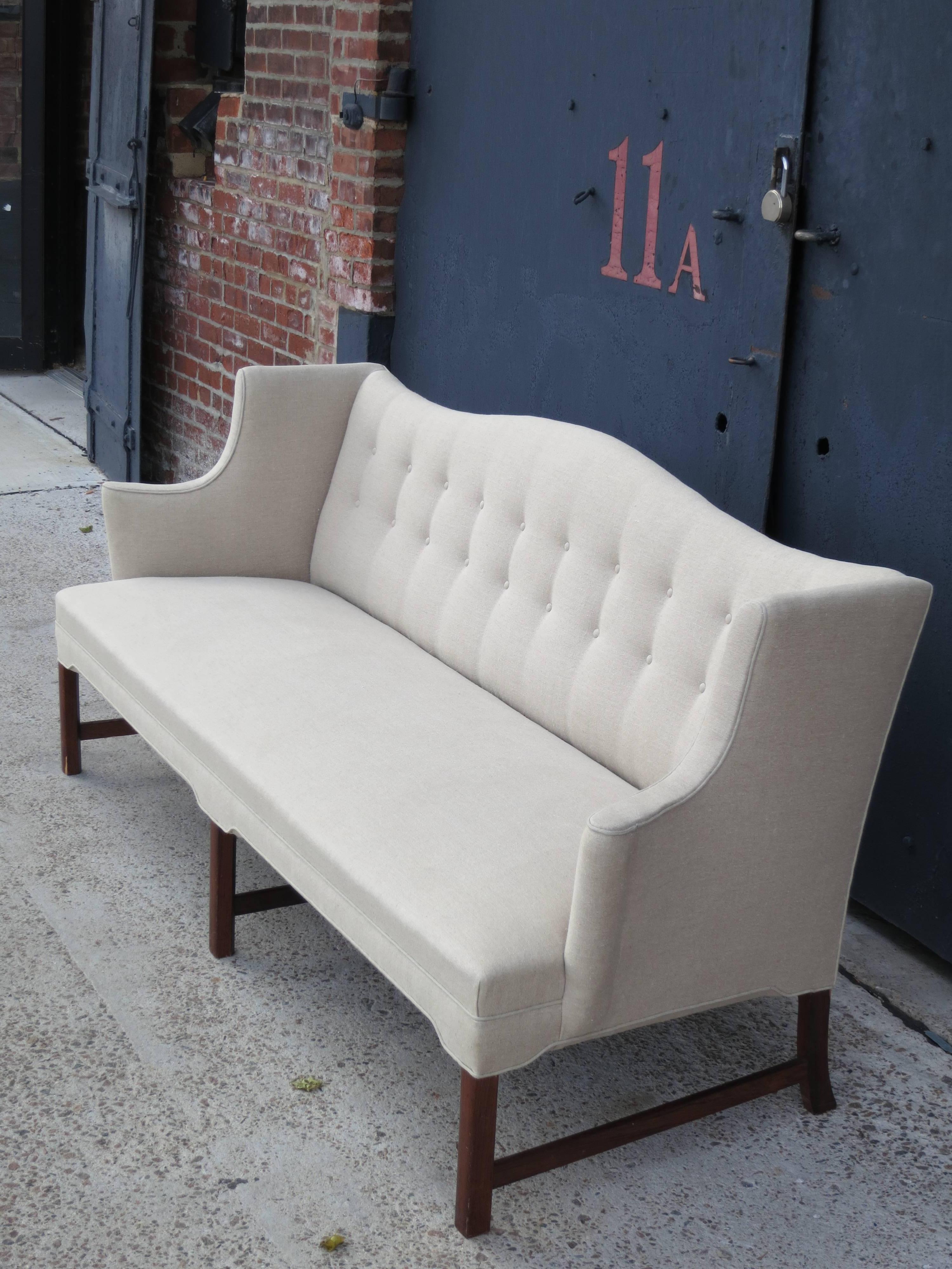 Elegant Camelback Sofa with Brazilian Rosewood Legs by Ole Wanscher. This elegant sofa with Brazilian rosewood legs was designed in the 1940s by Ole Wanscher and made by master cabinetmaker A.J. Iversen. It has been restored and newly upholstered in