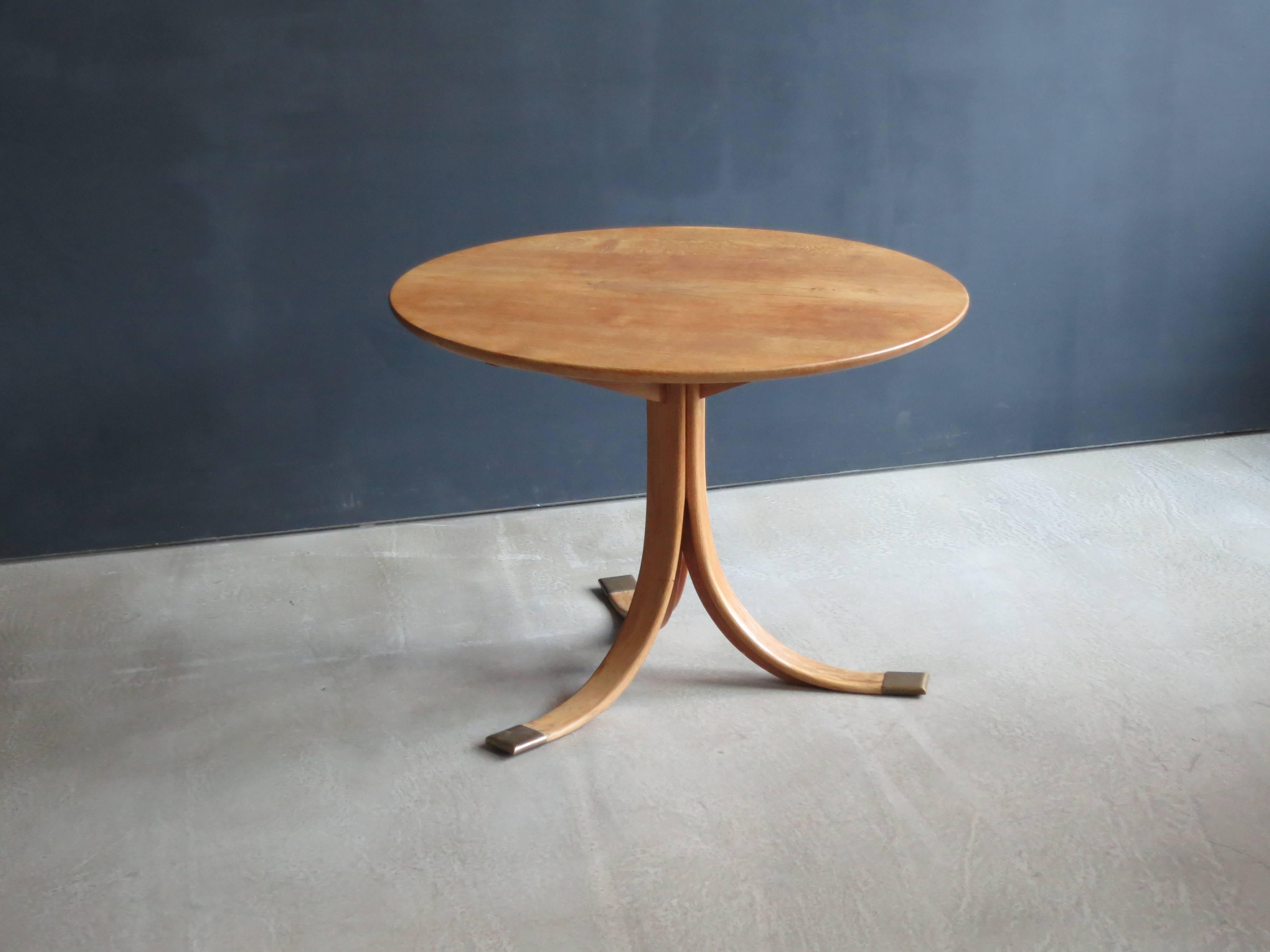 Modern in its spare simplicity, this beautifully constructed table is made of solid figured oak with patinated brass feet. It could be used as a side table for a furniture grouping or next to a bed, or as an occasional table.