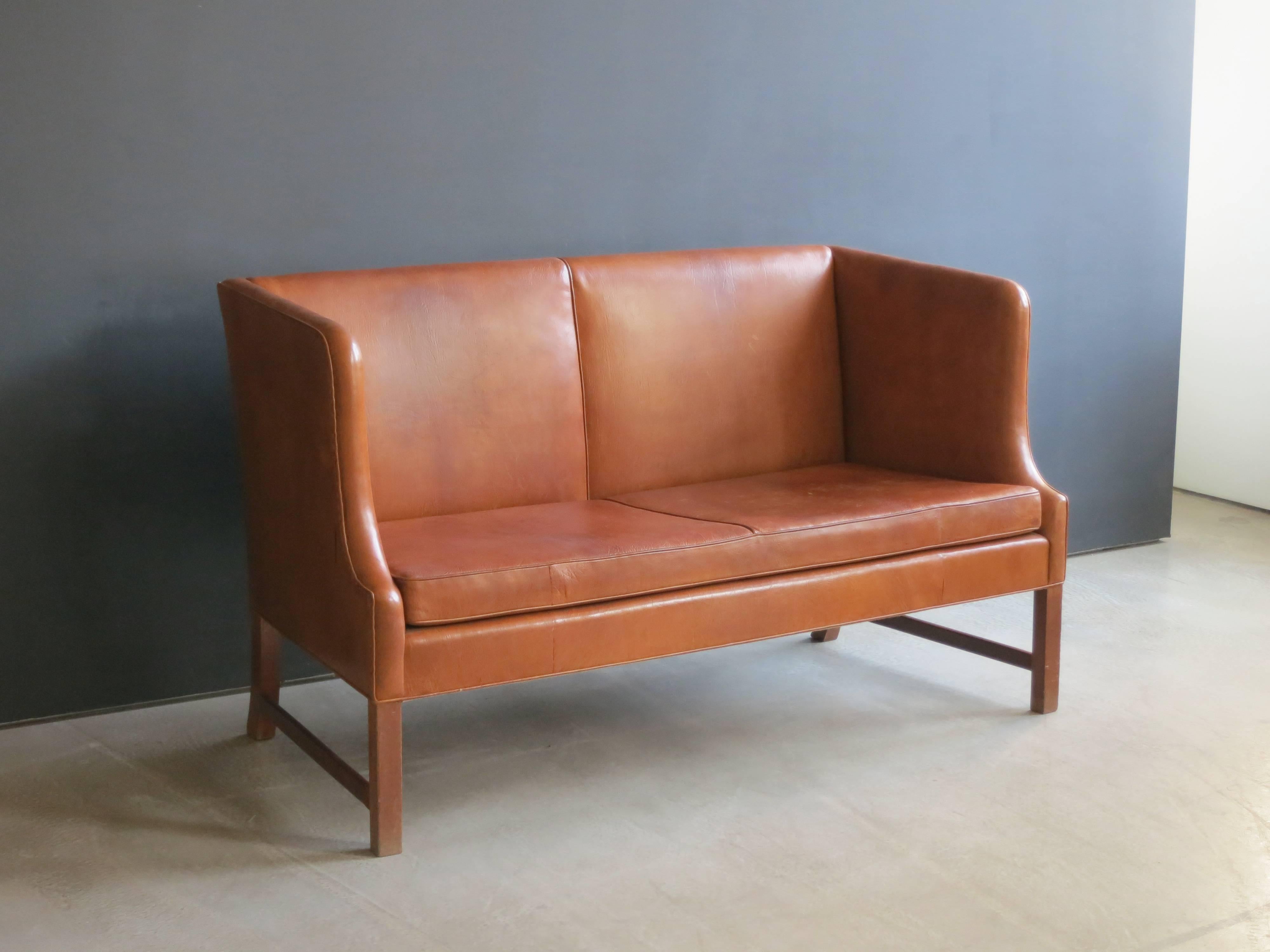 A well-proportioned and extremely comfortable sofa that was first presented at the 1937 World's Fair in Paris as part of the Danish Pavilion.

The legs are of cuban mahogany and the upholstery is of a highly patinated Nigerian goatskin.

Made by