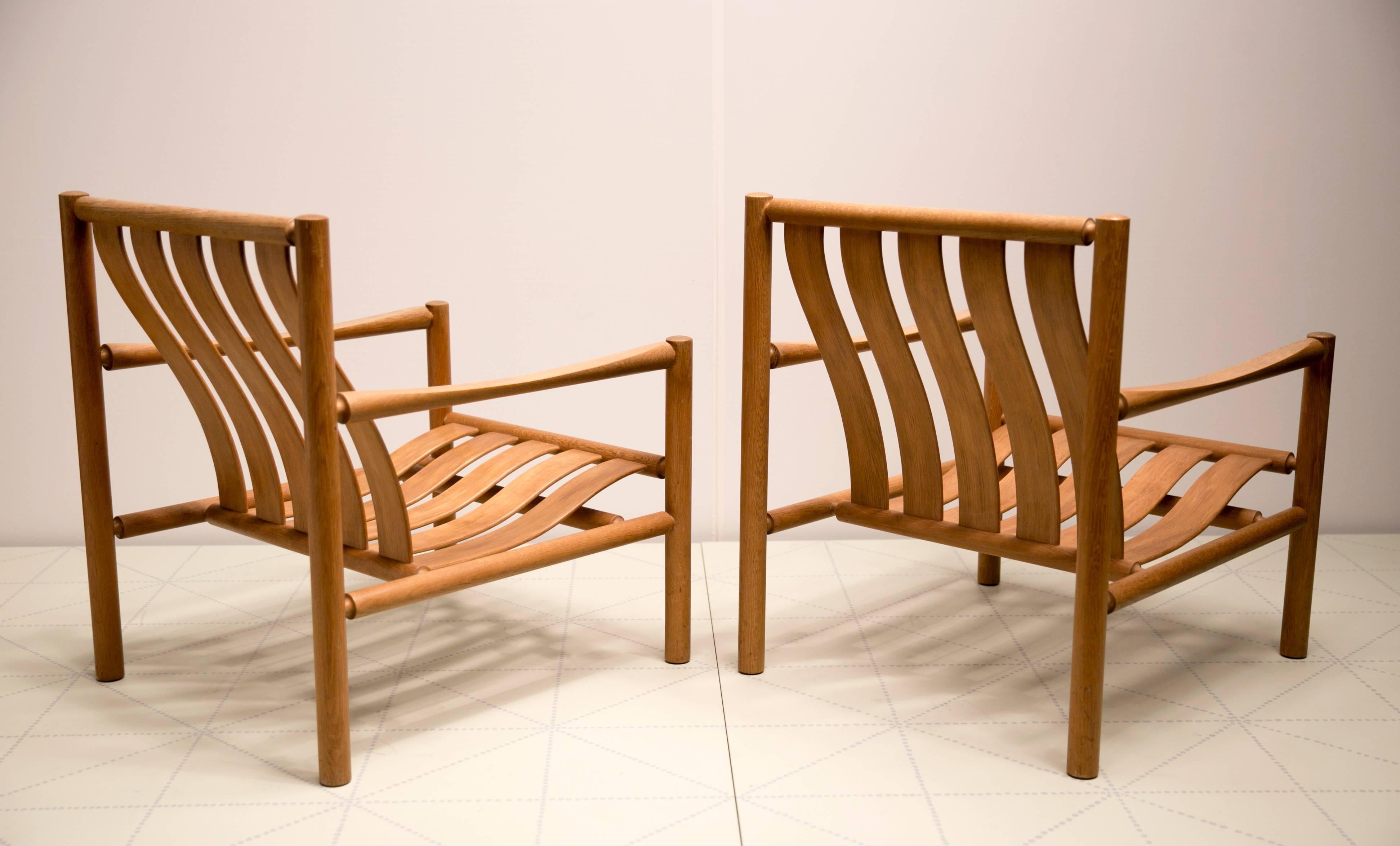 Pair of Handmade Slatted Oak Lounge Chairs by Jørgen Nilsson. This pair of rare easy chairs was designed by Jørgen Nilsson and made by the cabinetmaker J.H. Johanssens Eftf. They were first exhibited in 1964 at the Copenhagen Cabinetmakers' Guild