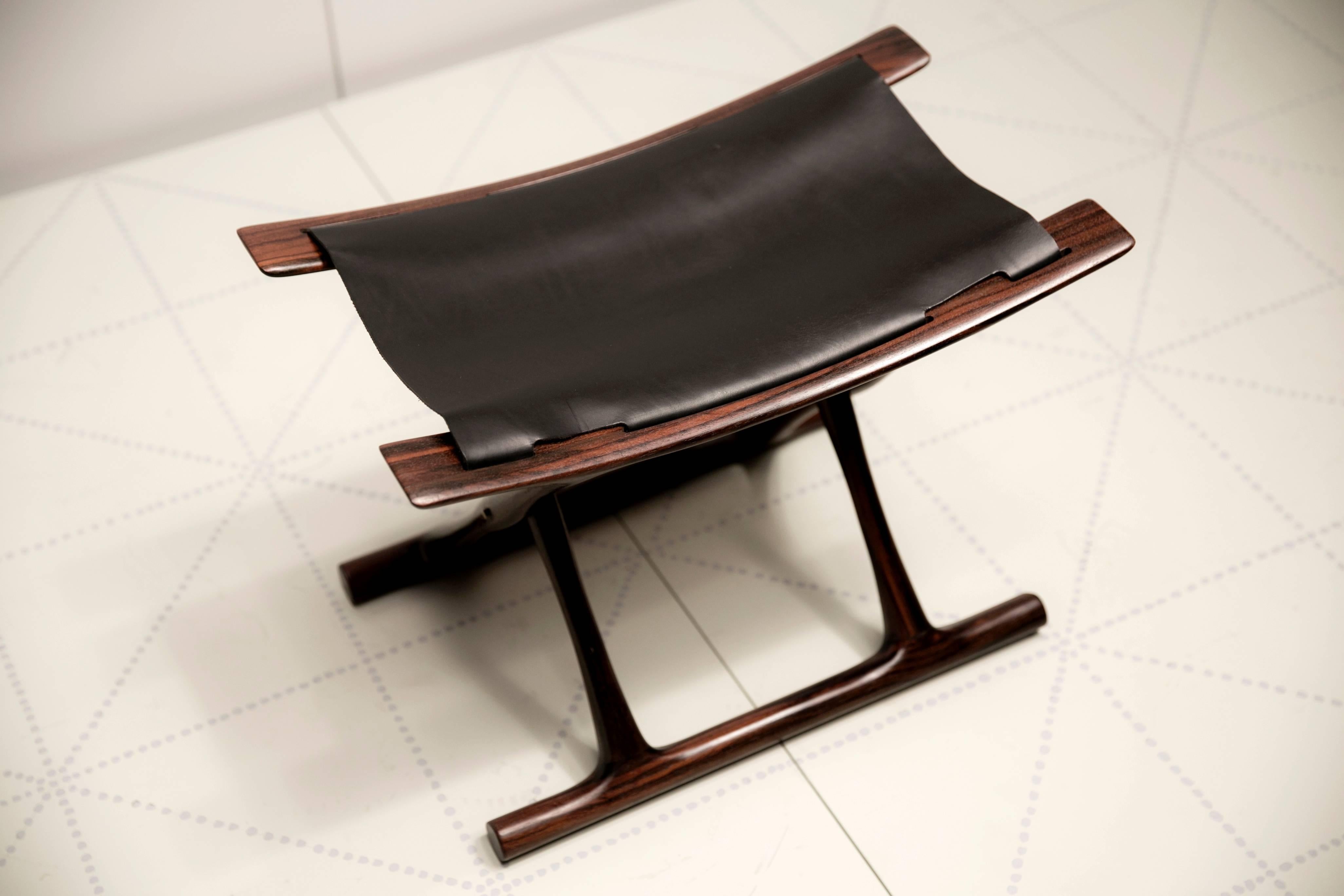 Cabinetmaker P.J. Furniture, Copenhagen (cabinetmaker's plaque on the underside of the stool).

Designed 1957; this stool made in 2000.

Indian rosewood, black leather (additional matching examples are available in both rosewood and