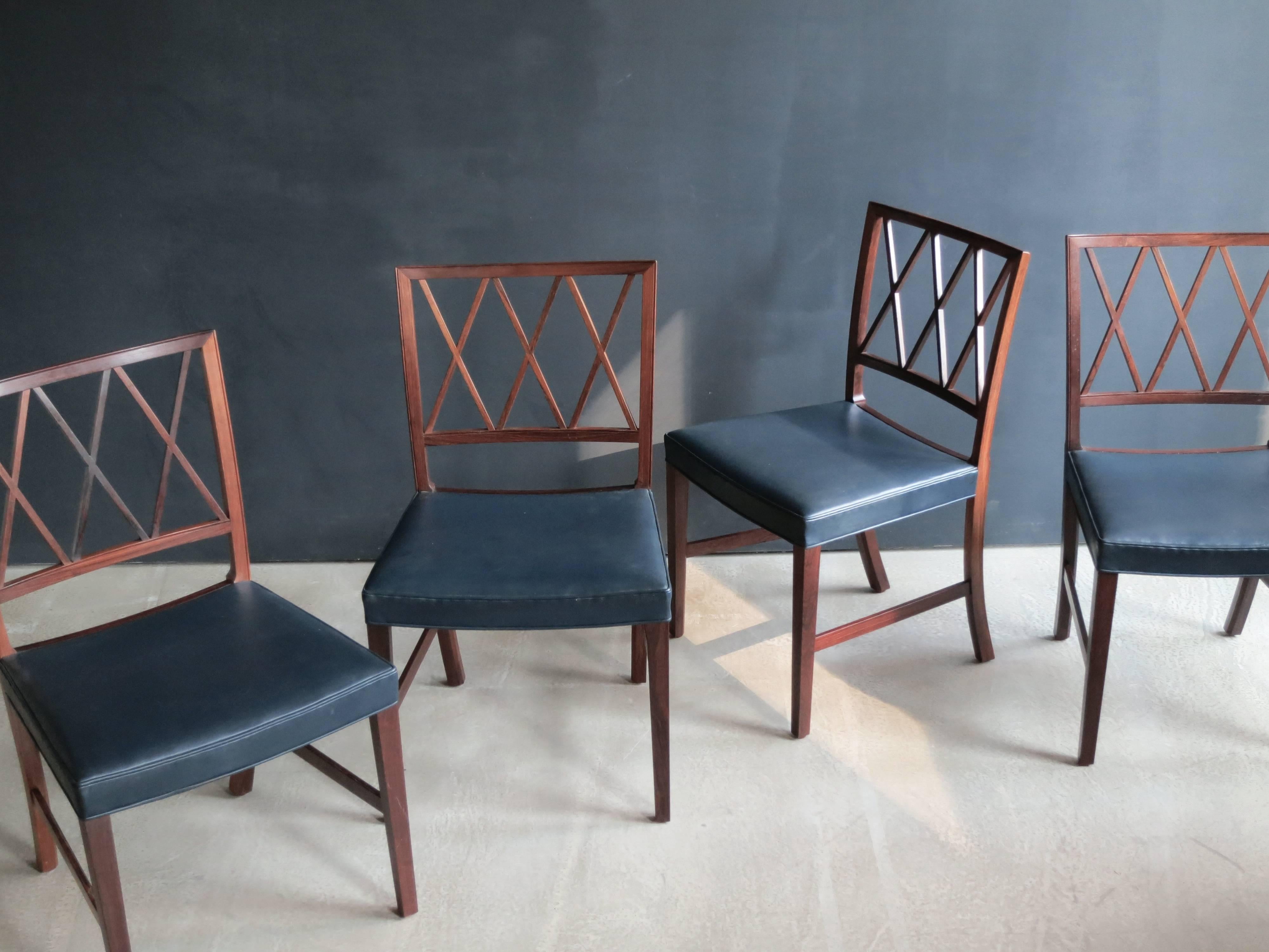 This large group of twelve matching cross-backed dining chairs appears light and airy due to the three molded X-forms across the back of each chair. The well proportioned seat and pitch of the back make this a very comfortable chair for long