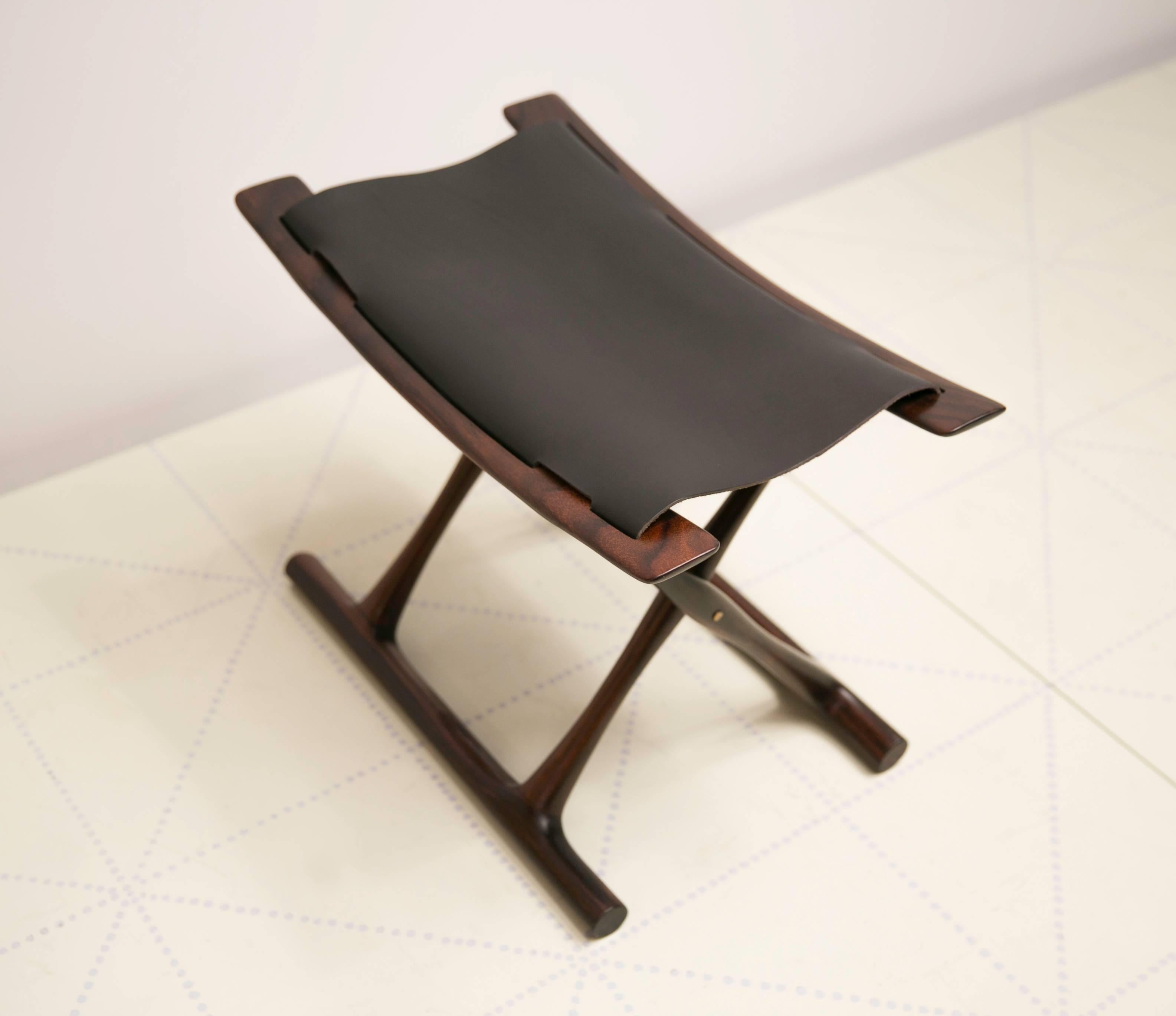 Egyptian Folding Stool by Ole Wanscher in Indian Rosewood and Black Leather. Wanscher's Egyptian stool is one of the icons of Danish design. As was typical of Wanscher, he looked back to previous furniture forms for inspiration and
