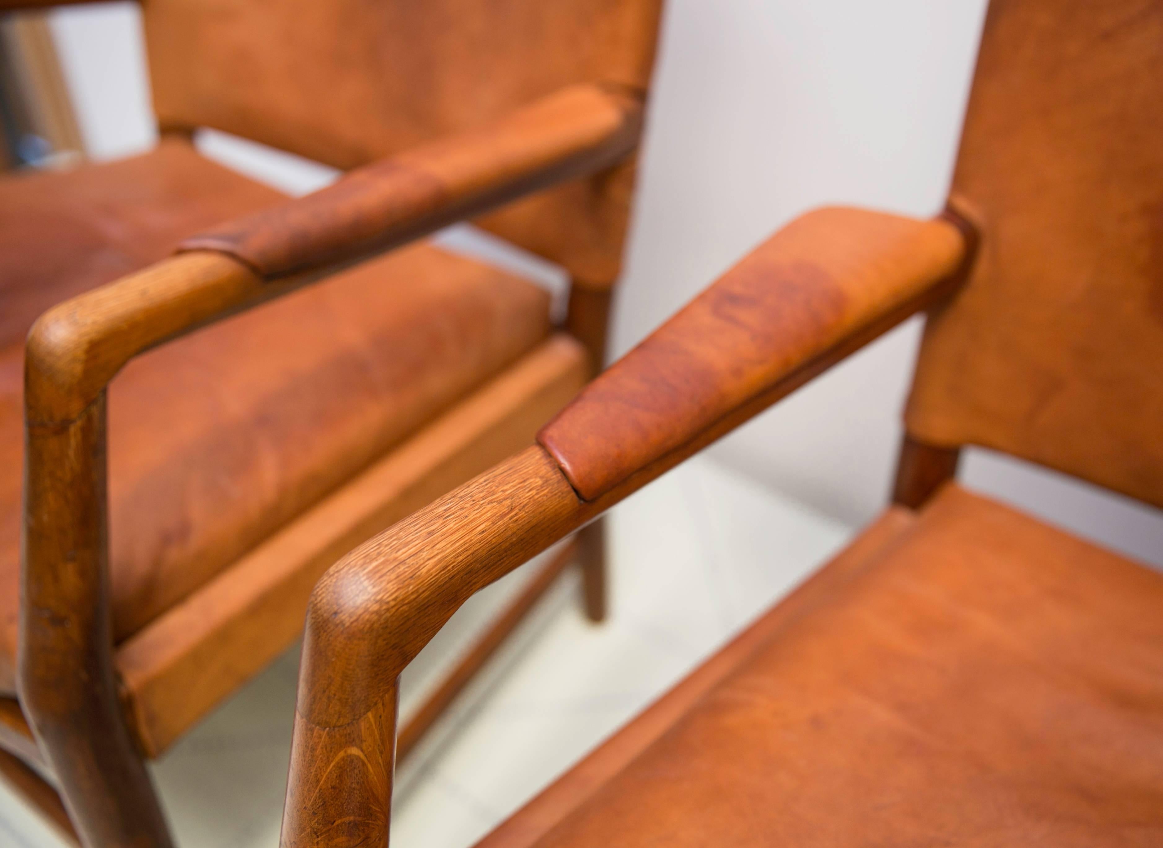 Danish Pair of Early Easy Chairs by Hans Wegner in Oak and Original Patinated Leather For Sale