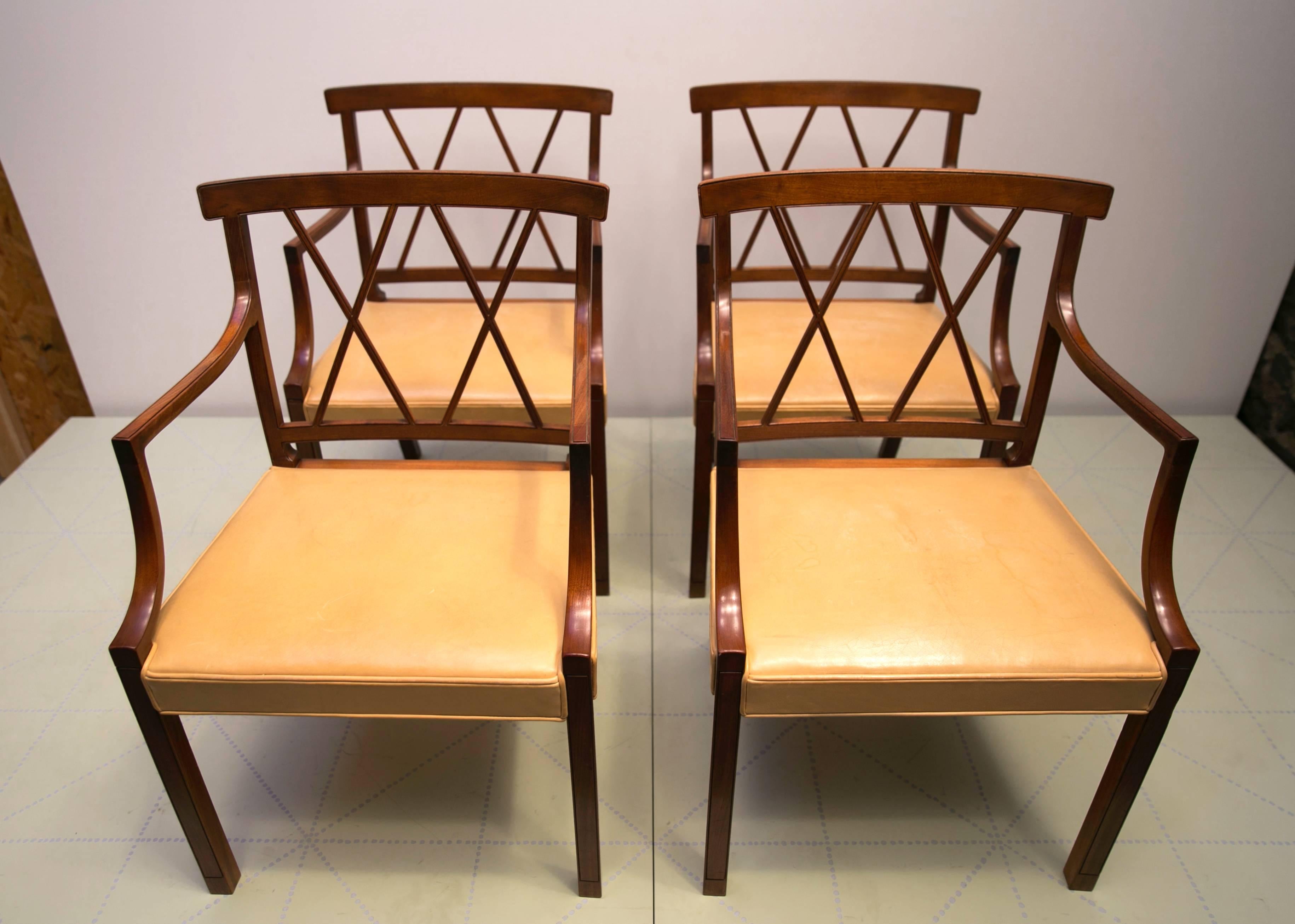 Four Elegant Armchairs by Ole Wanscher, Cuban Mahogany and Original Pale Leather. These elegant and beautifully detailed armchairs were designed by Wanscher in 1943. As is typical of Wanscher and his master cabinetmaker A.J. Iversen, the delicate