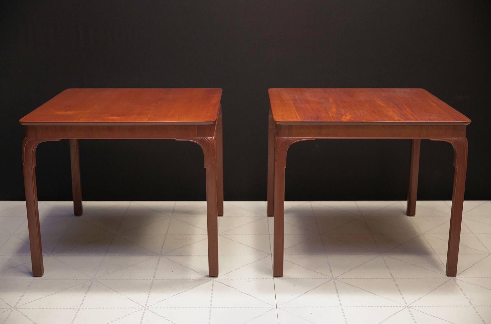 Frits Henningsen's Monumental Side Tables, Solid Cuban Mahogany and Carved Legs. Frits Henningsen designed this table in the 1930s as a games or cafe table with a chair clearance of 26 5/8 inches under the apron. 

Today, these tables could also be