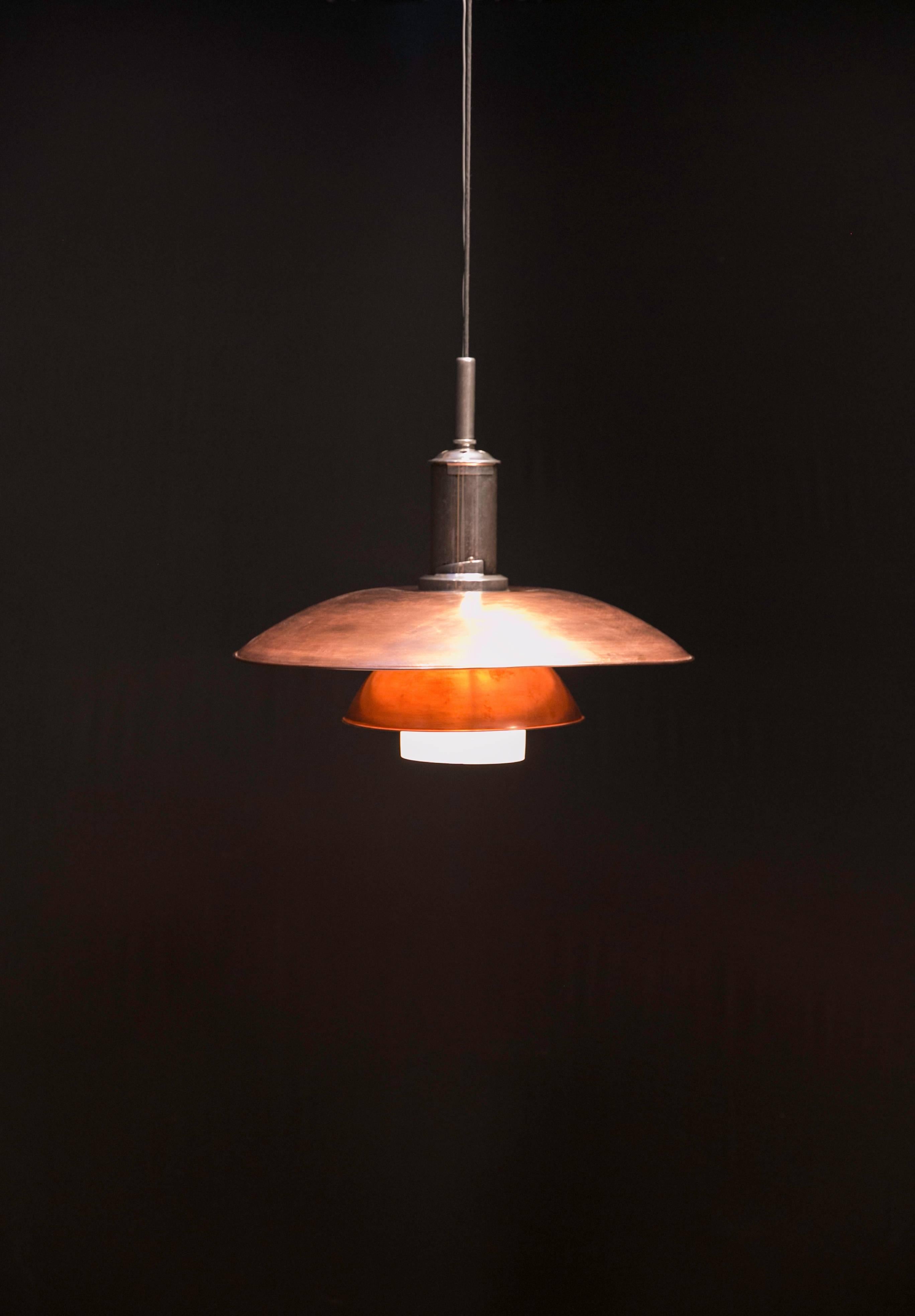 This rare and large pendant lamp was designed and made by Poul Henningsen, circa 1929. Marked with the model number and patented on the nickel shade holder. The top and middle shades are of patenated copper. The lower shade and bowl are of matte