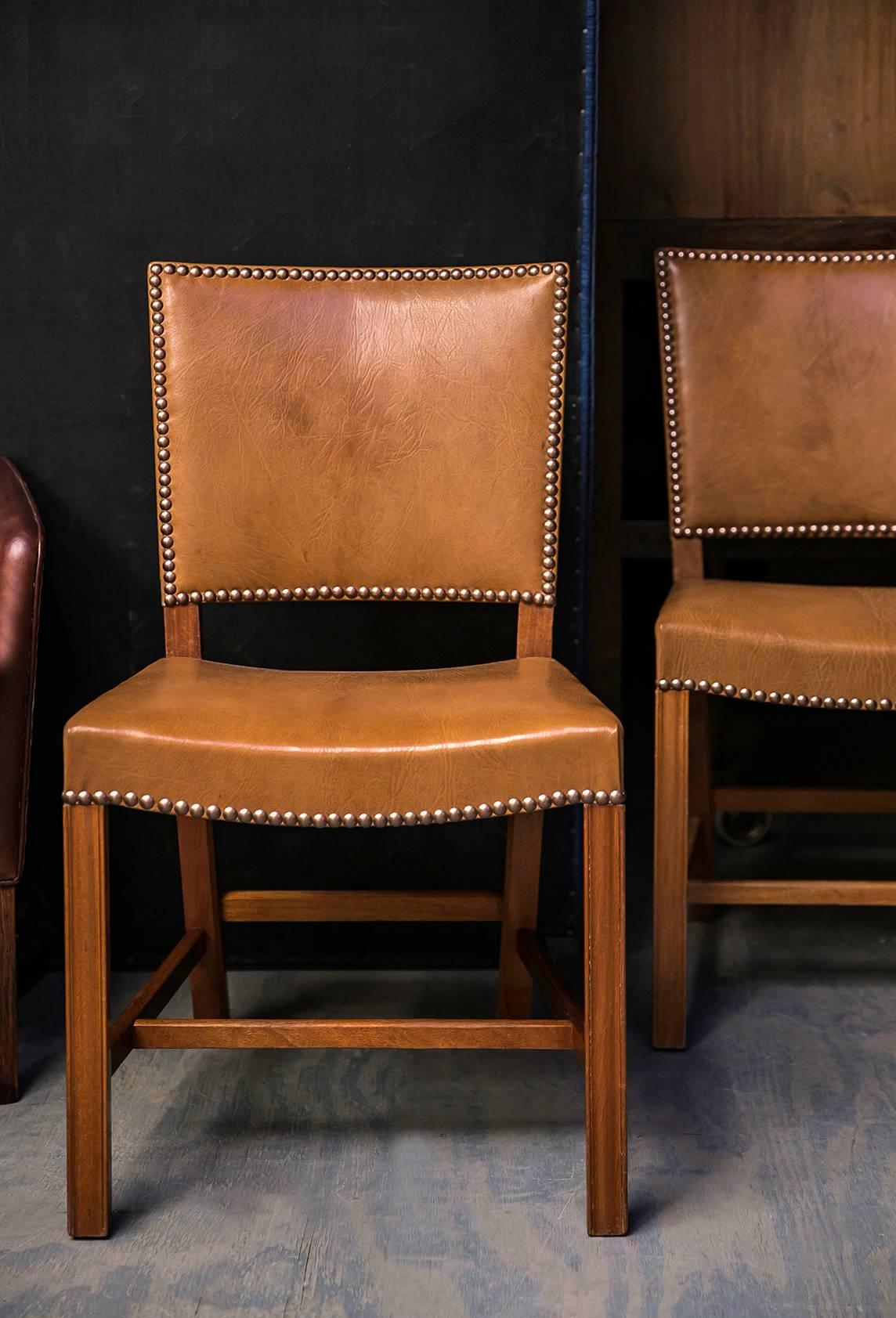 This highly coveted set of chairs by Kaare Klint was made by master cabinetmaker Rud Rasmussen in mahogany and the Nigerian goatskin upholstery with brass nails for which Klint was best known. Nigerian goatskin has an expressive texture that is