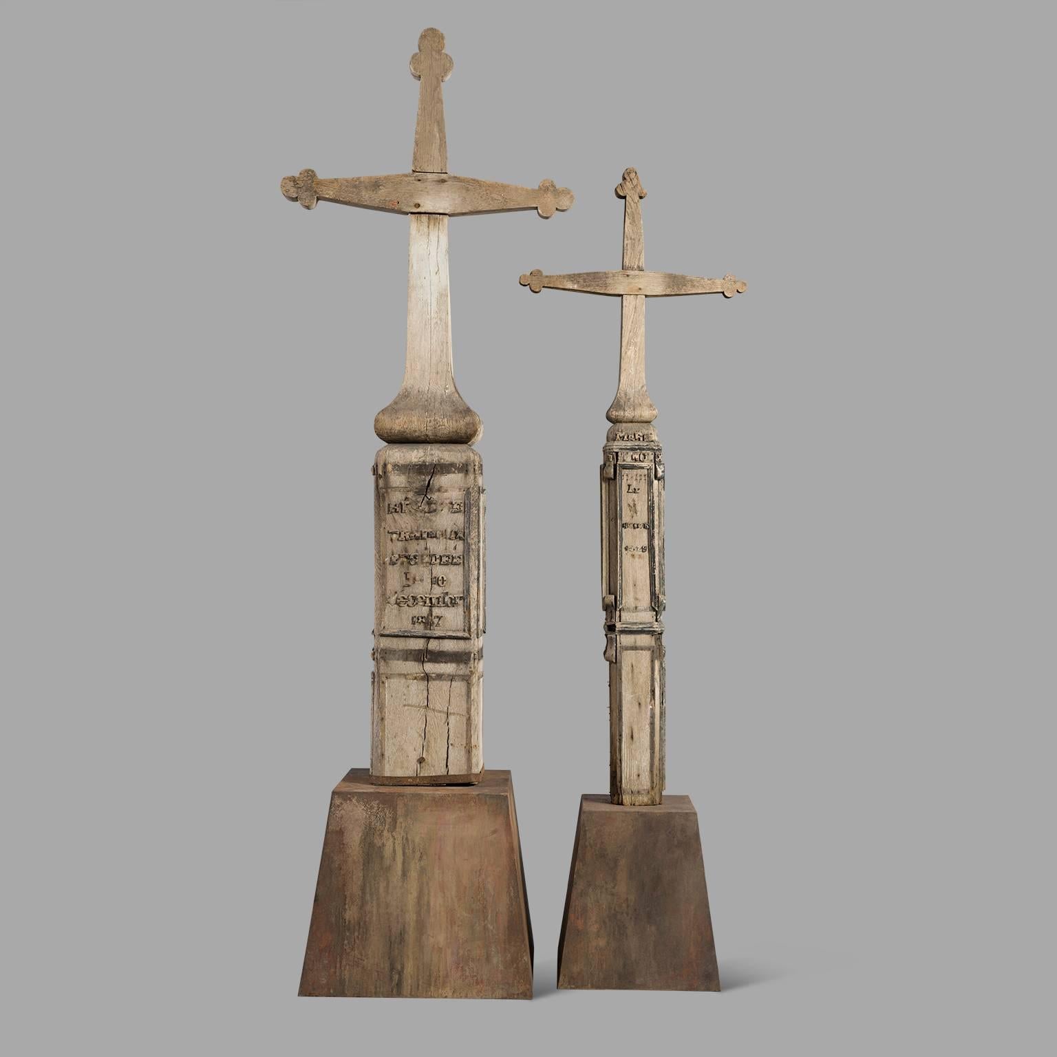Both carved crosses are from the same family, probably two sisters. Despite the many flaws in their lettering, one can still read 'Marie 1889' and 'Helen, died on December 1887 10th'.
They are mounted on a contemporary base preserving their