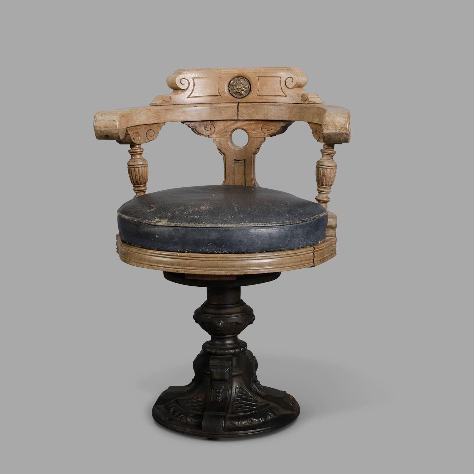 Blond mahogany with cast iron pedestal and coated canvas seat. To facilitate the use of this chair once fixed to the ground, the seat rotates on an off-axis pivot to ease leaving from desk or table.
The cast iron base is signed 
