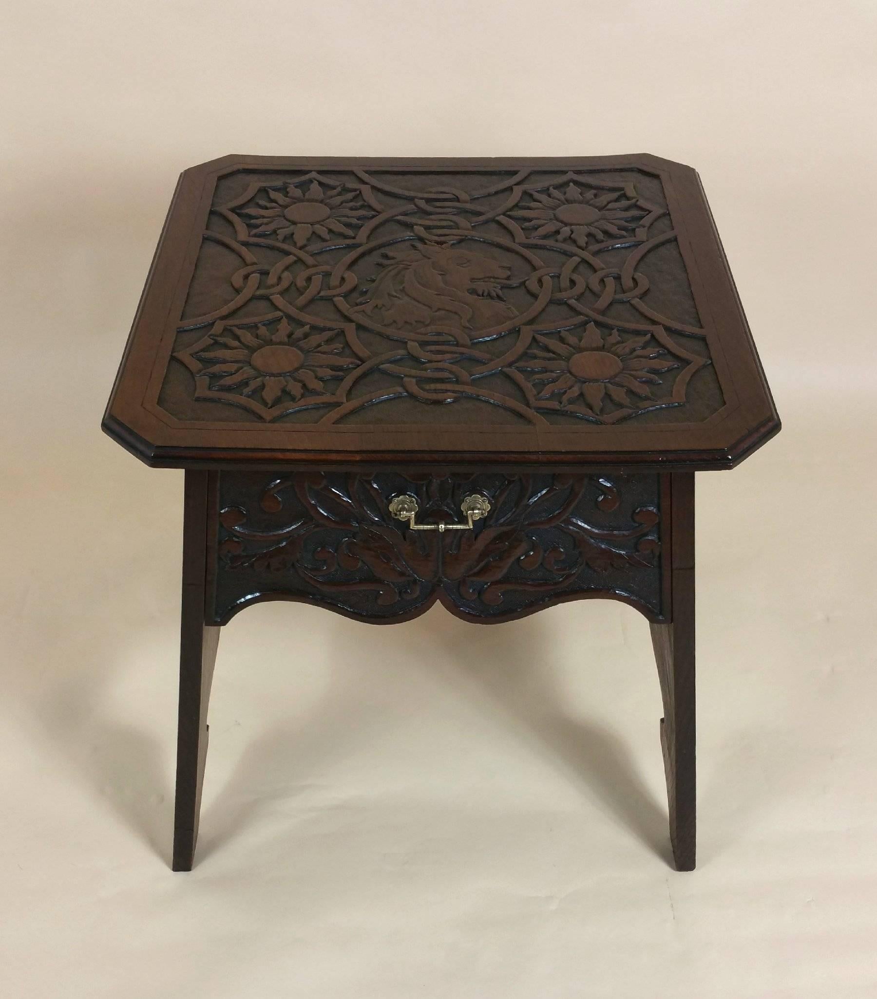 This magnificent and very handsome 19th century Arts and Crafts oak centre table features an ornate and highly detailed carving of sunflowers and Celtic strap work with a lion’s head central design. The table has one deep drawer and a stretcher