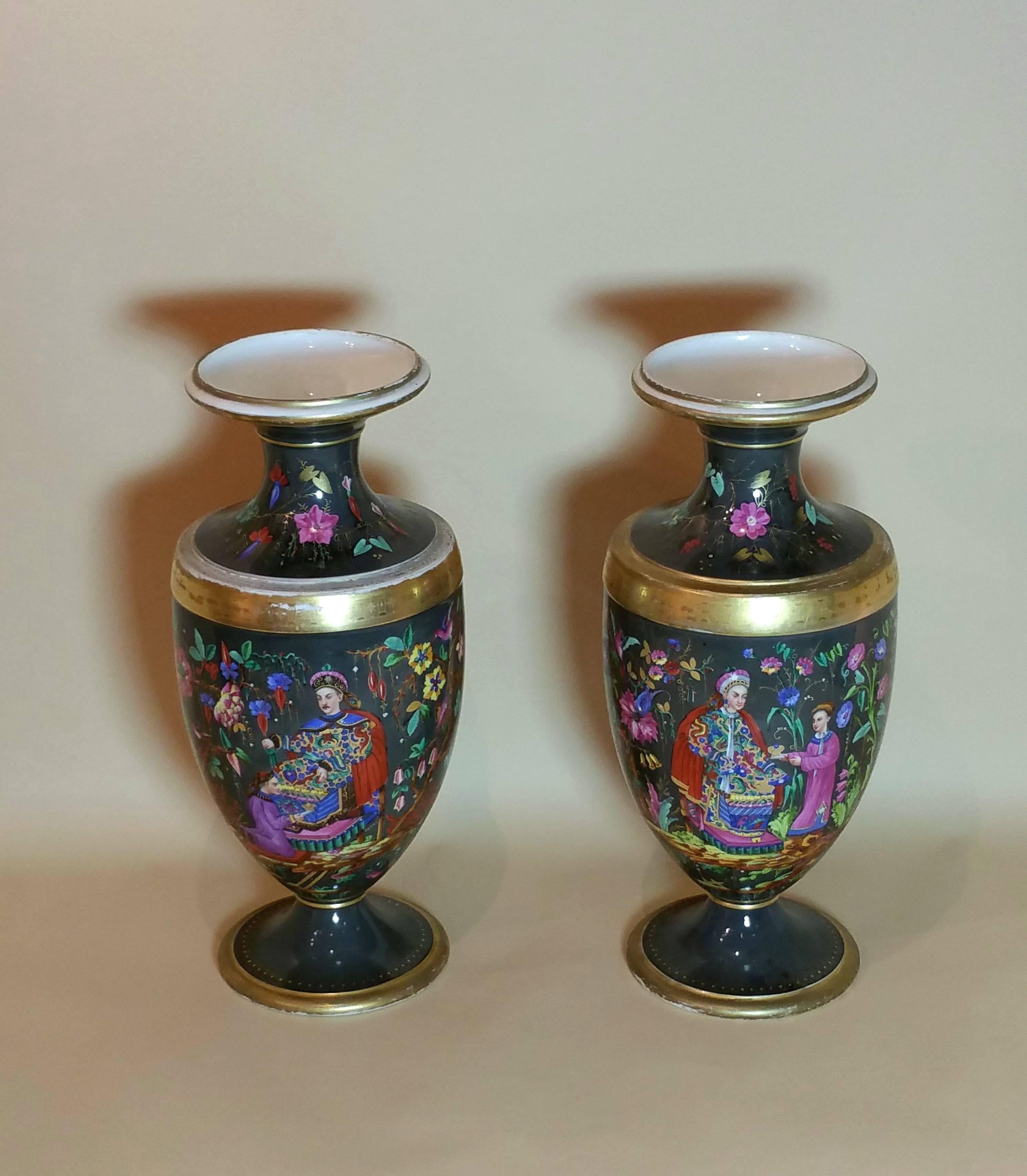 These beautiful and quite striking pair of French vases feature a painted scene with chinoiserie figures against a grey black background with gold leaf trim and are mid-19th century. They each measure 7 ½ in – 19 cm in diameter and Stand 18 ¼ in –
