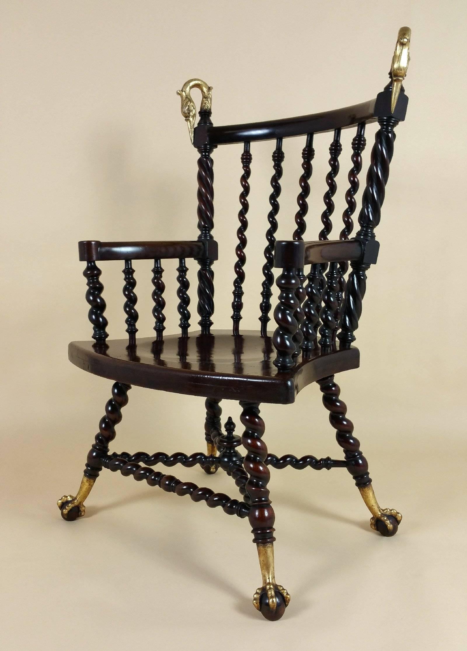 This truly superb and stunning American mahogany armchair features barley twist supports and back slats with a recessed seat. The chair showcases two lovely gilt bronze swans, one on each side of the chair back, and wonderfully curved arm supports.