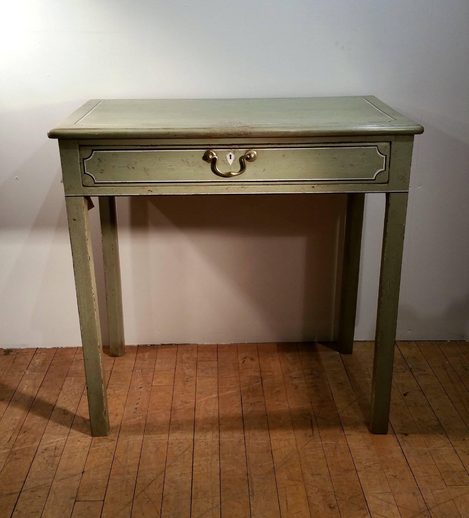 A very handsome George III painted single drawer side cabinet, painted in a pale lime green wash, features a single top drawer to the front, with faux designed drawers to either side, all with matching brass pull handles. The table stands on sturdy