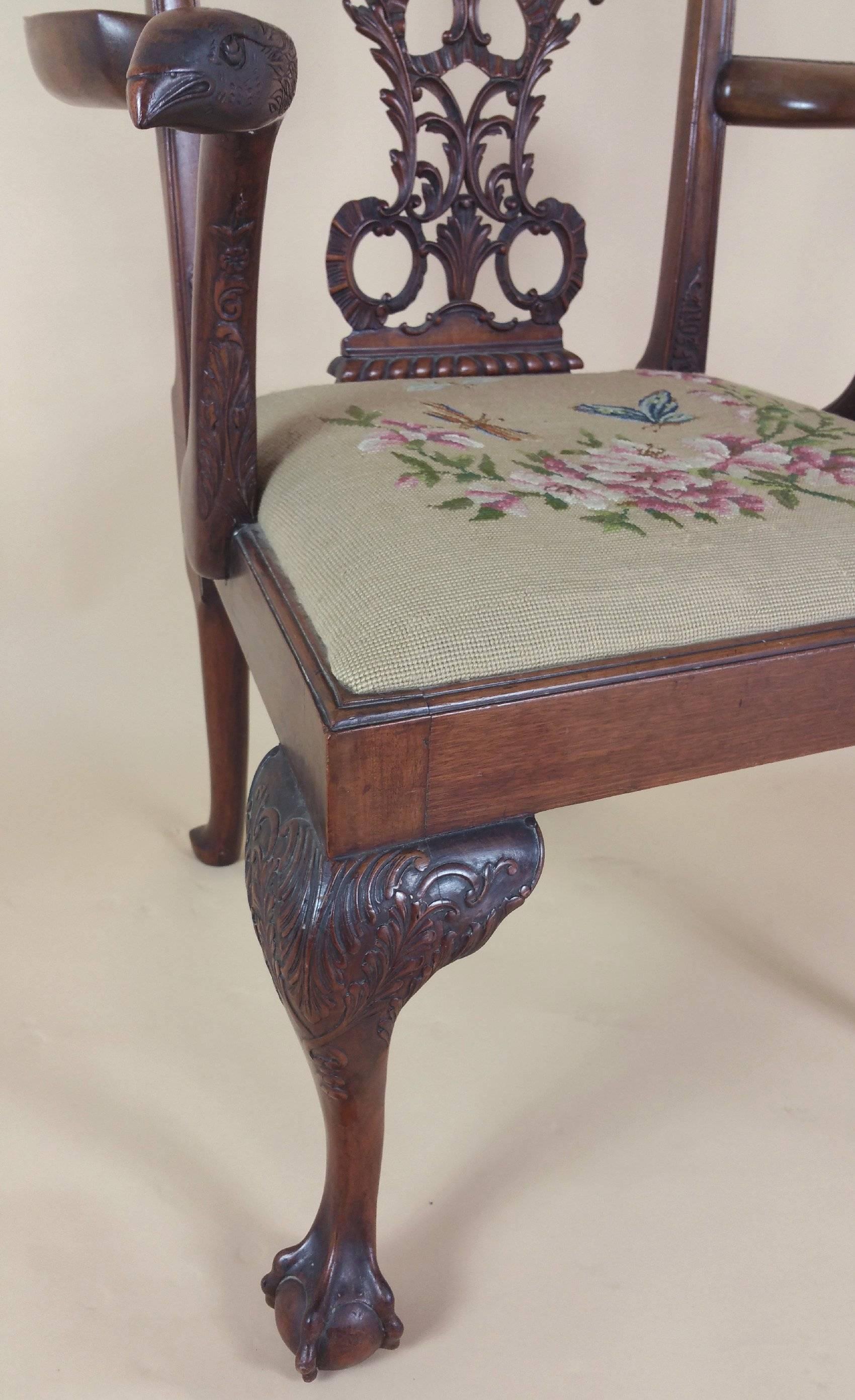 A very handsome and elegant looking Chippendale style mahogany elbow chair with ribbon carved back, Eagle head arms and ball and claw feet supports with a tapestry upholstered seat. Each chair measures 26 in, 66 cm wide, 18 ½ in, 47 cm deep and 42 ½