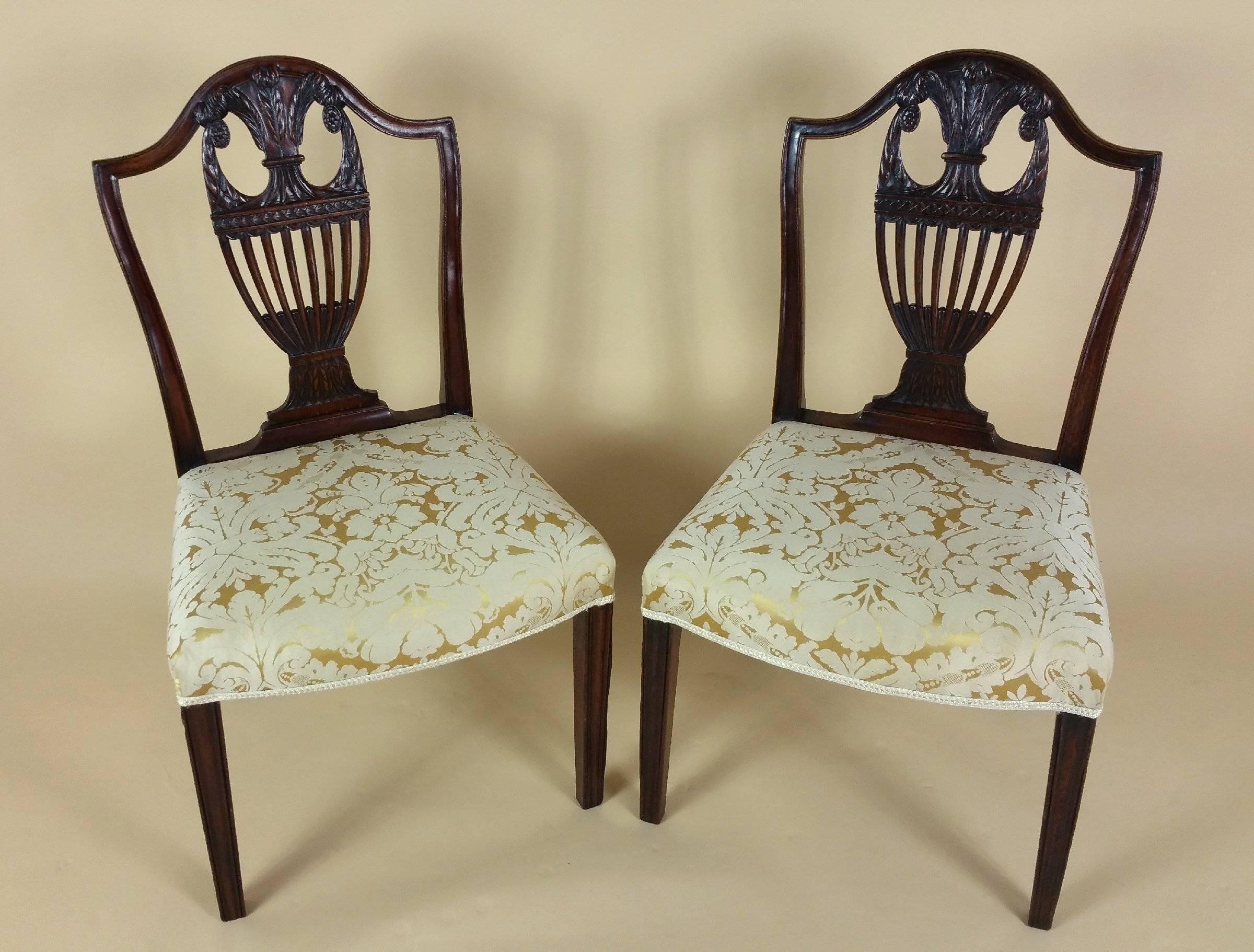 This lovely pair of George III carved mahogany side chairs feature Prince of Wales feather backs and are upholstered in a light gold silk Damask. Each chair measures 21 in – 53.3 cm wide, 19 in – 48.2 cm deep and 37 in – 94 cm high, with a seat