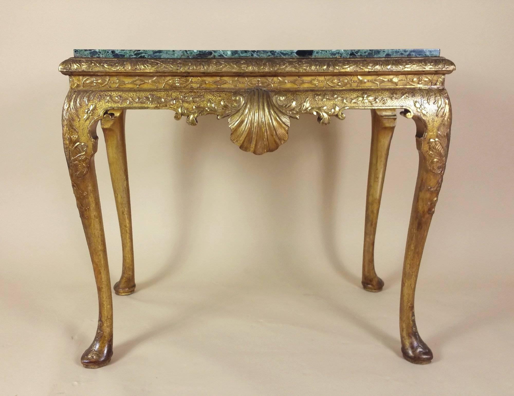 This stunning and very attractive carved giltwood and gesso pier table is designed the George I style, with a lovely green marble top. The table stands on cabriole legs with pad feet, as well as carved detailing along the front and both sides, with