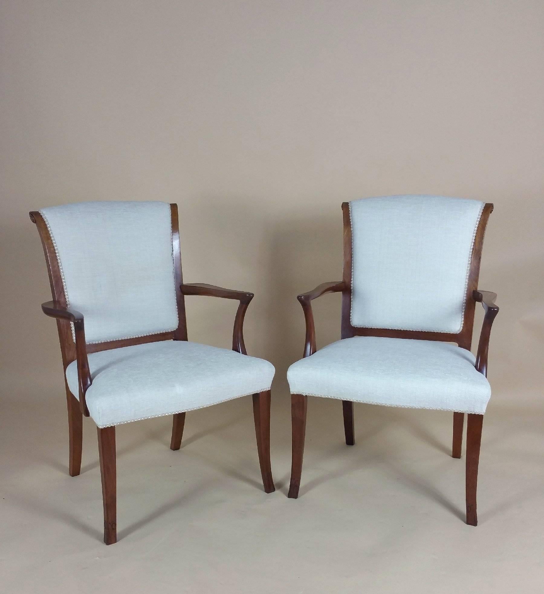 This lovely set of six teak 1930s elbow chairs are upholstered in an ivory woven material and feature carved detailing. Each chair measures 23 ¼ in - 59 cm wide, 21 in – 53.3 cm deep and 38 ½ in – 97.8 cm in height, with a seat height of 17 in- 43.2