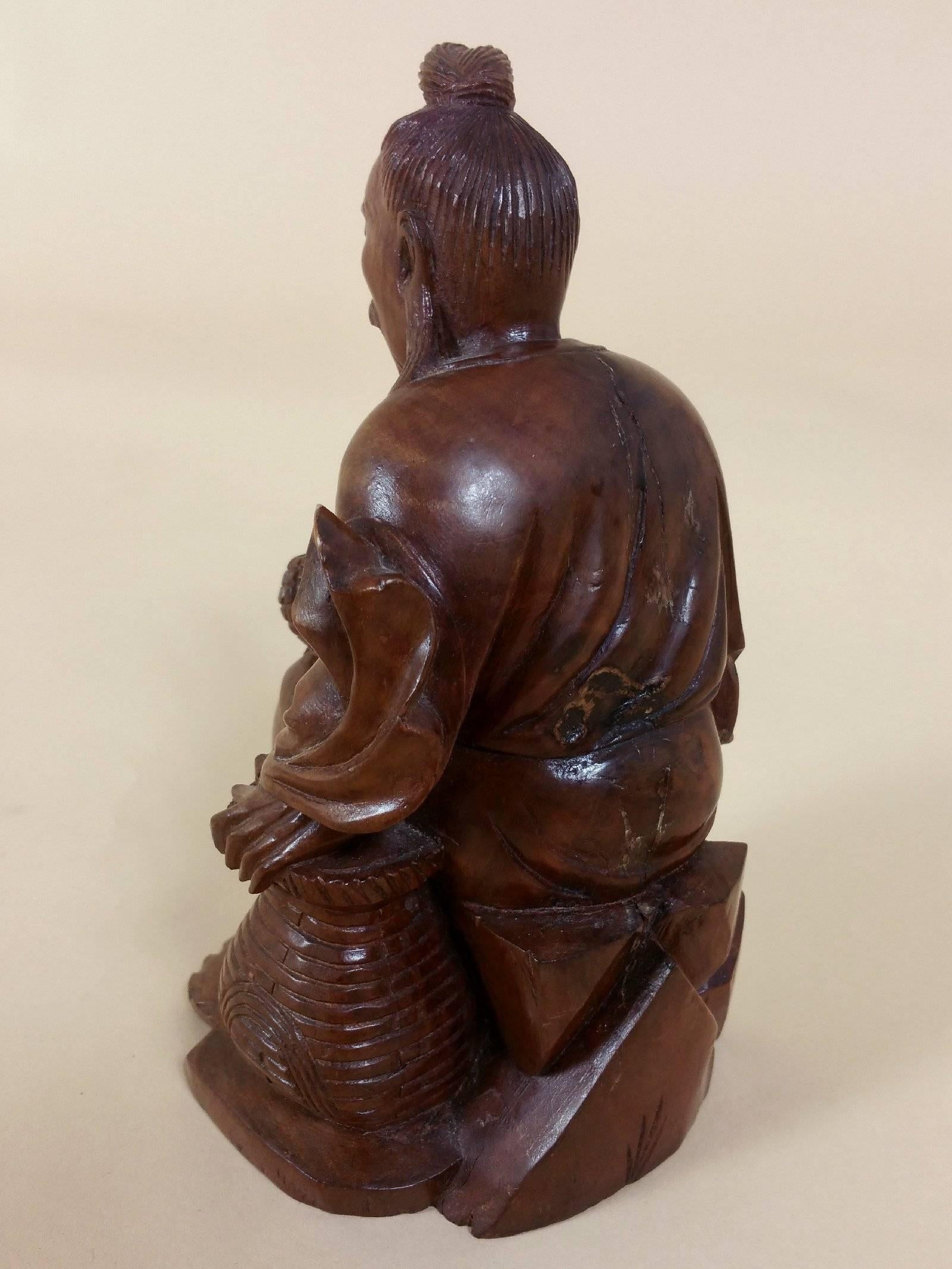 19th Century Japanese Fruitwood Carving of a Gentleman Smoking a Pipe
