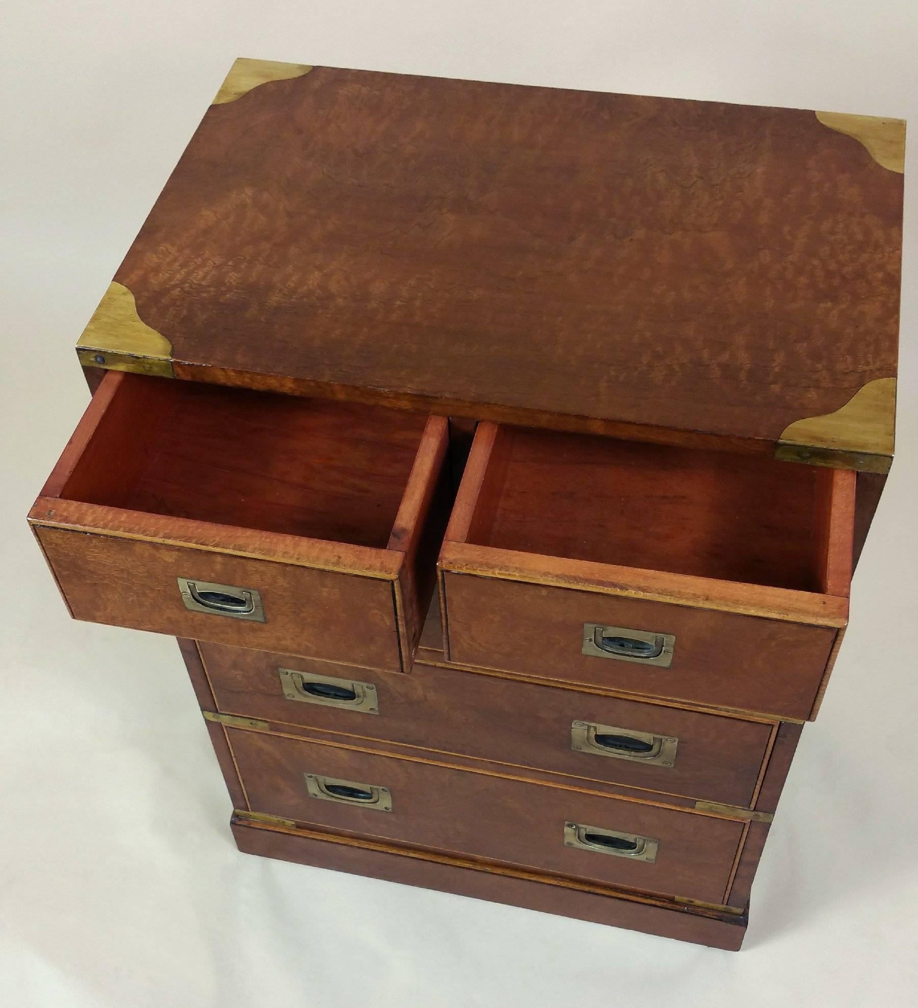 This striking and very well proportioned satinwood military chest features brass trim and handles, as well as side carrying handles. The chest has two top drawers with three long drawers beneath. It measures 21 in - 53.3 cm wide, 13 3/4 in - 35 cm